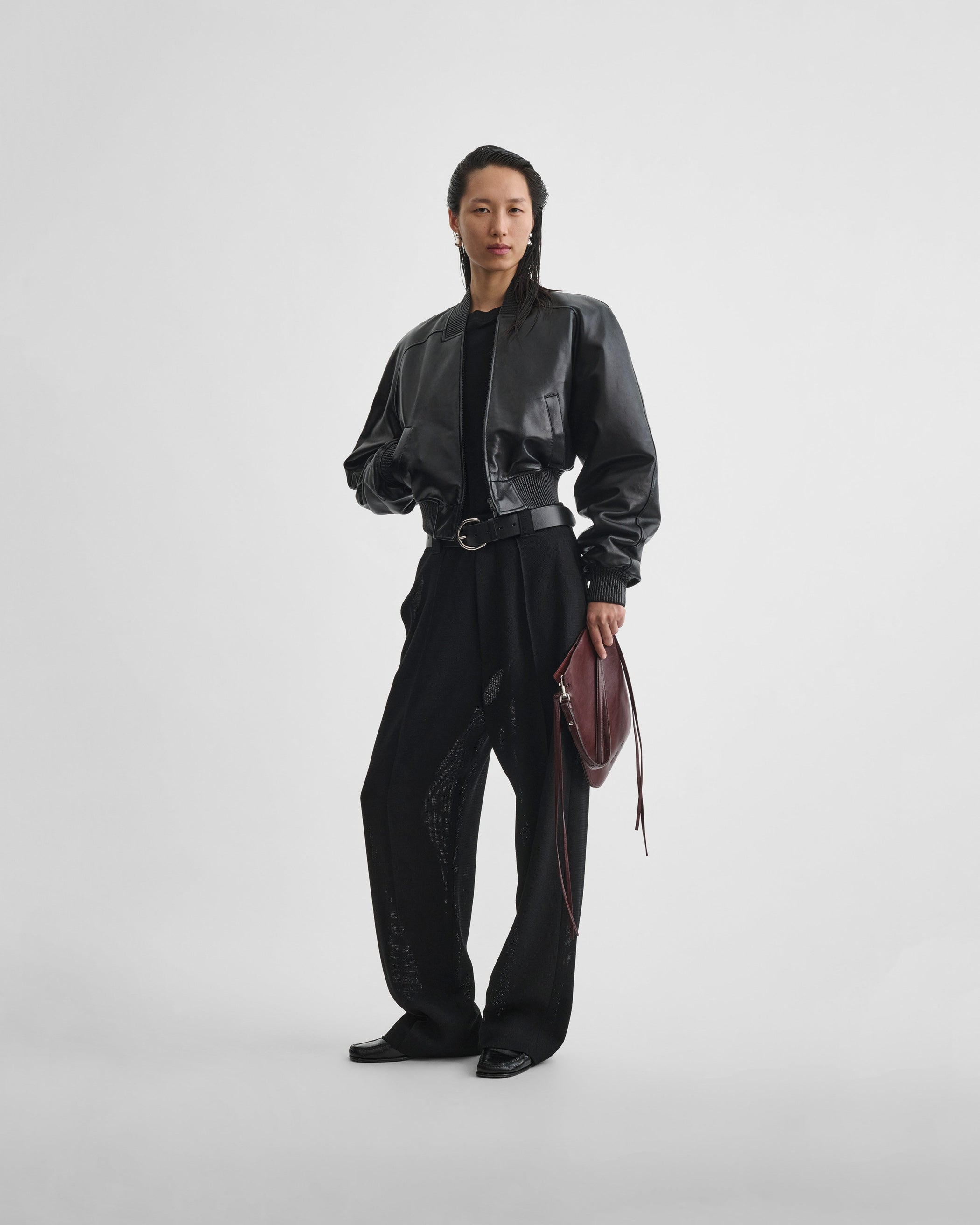 Full length front view of model wearing SHRUNK BOMBER in black leather