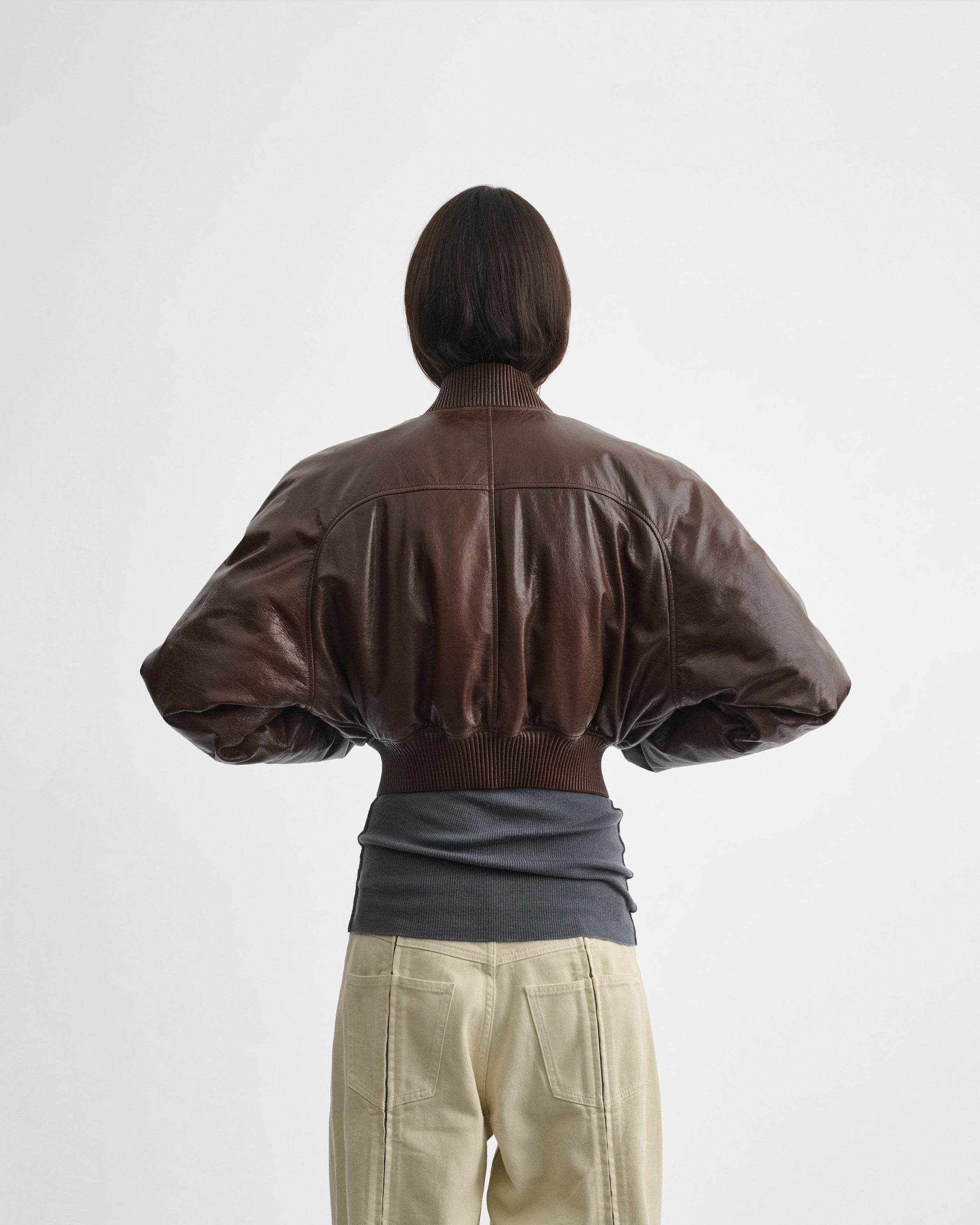 Back view of model wearing SHRUNK BOMBER in tobacco leather