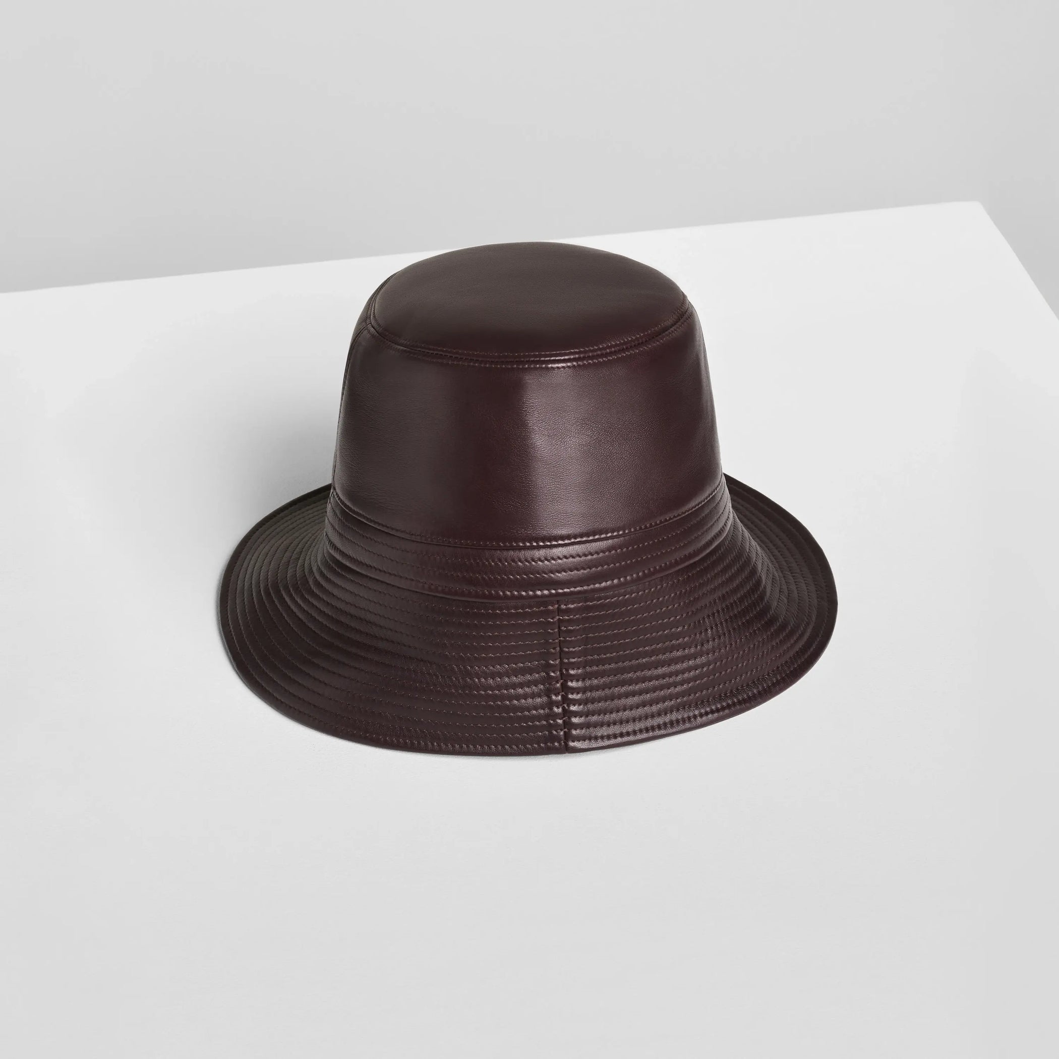 Flat back view of BUCKET HAT in dark berry leather