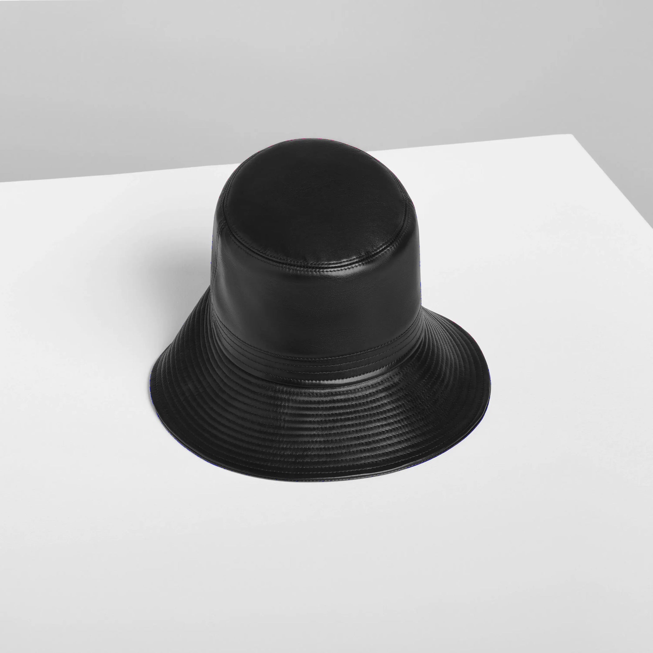 Flat front view of BUCKET HAT in black leather