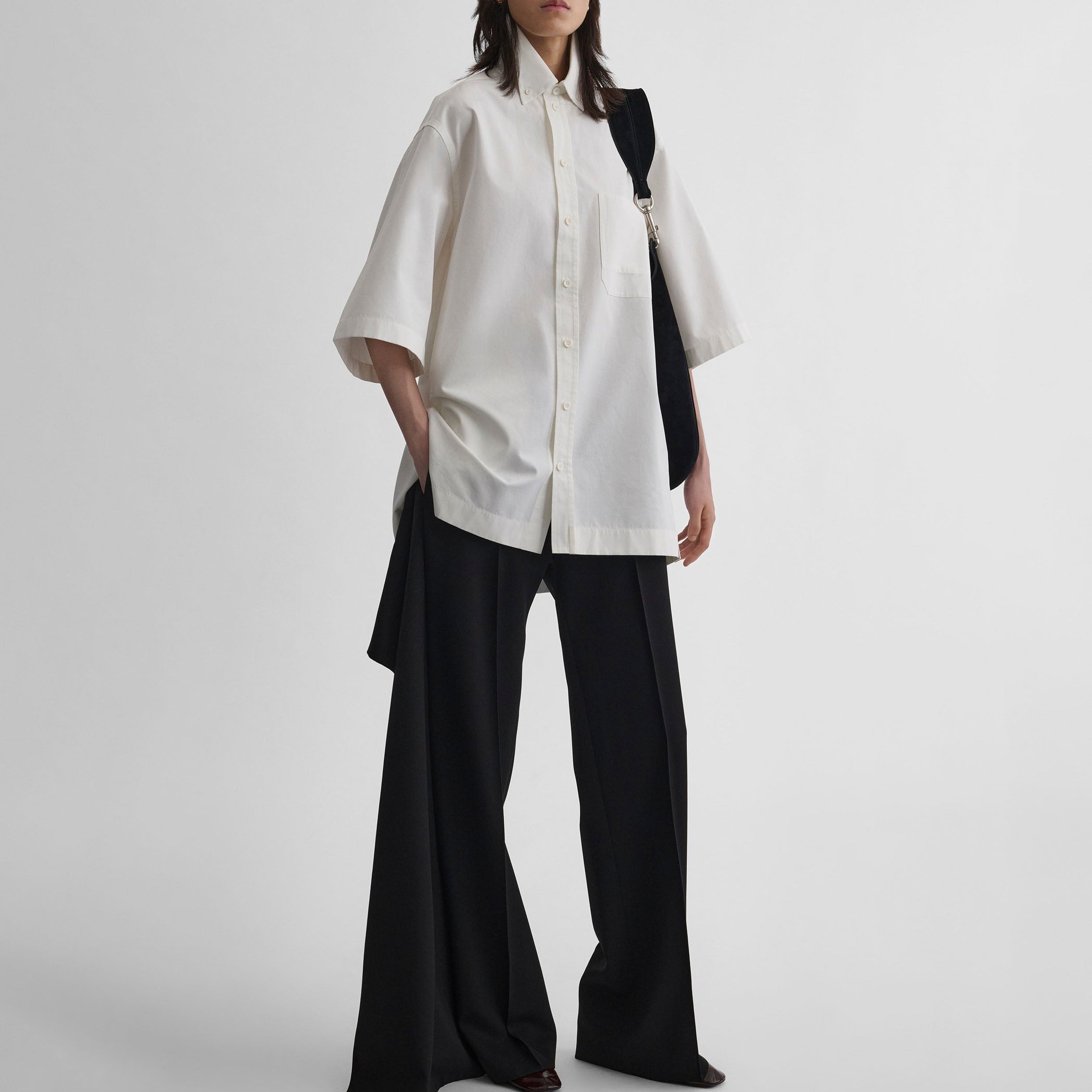 Front view of model wearing UNIFORM SHIRT in white cotton