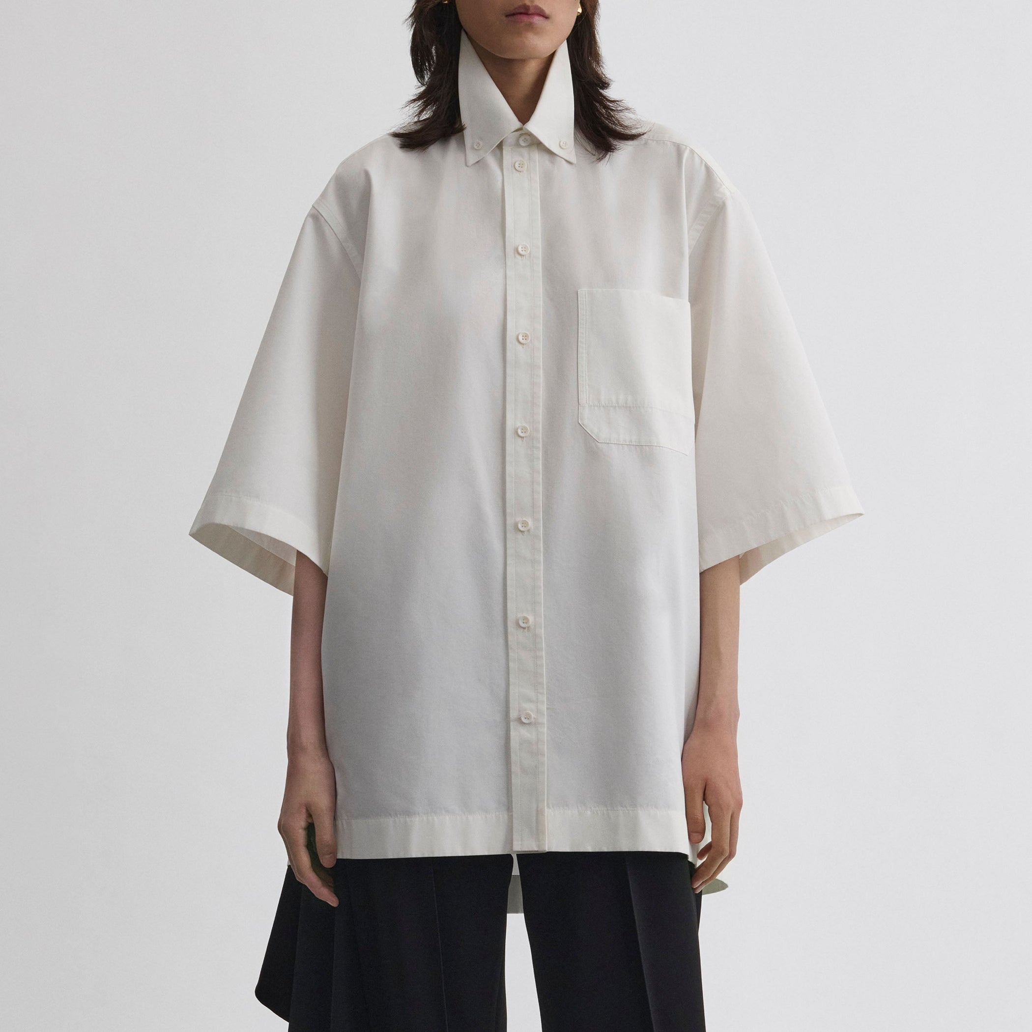 Close up front view of model wearing UNIFORM SHIRT in white cotton