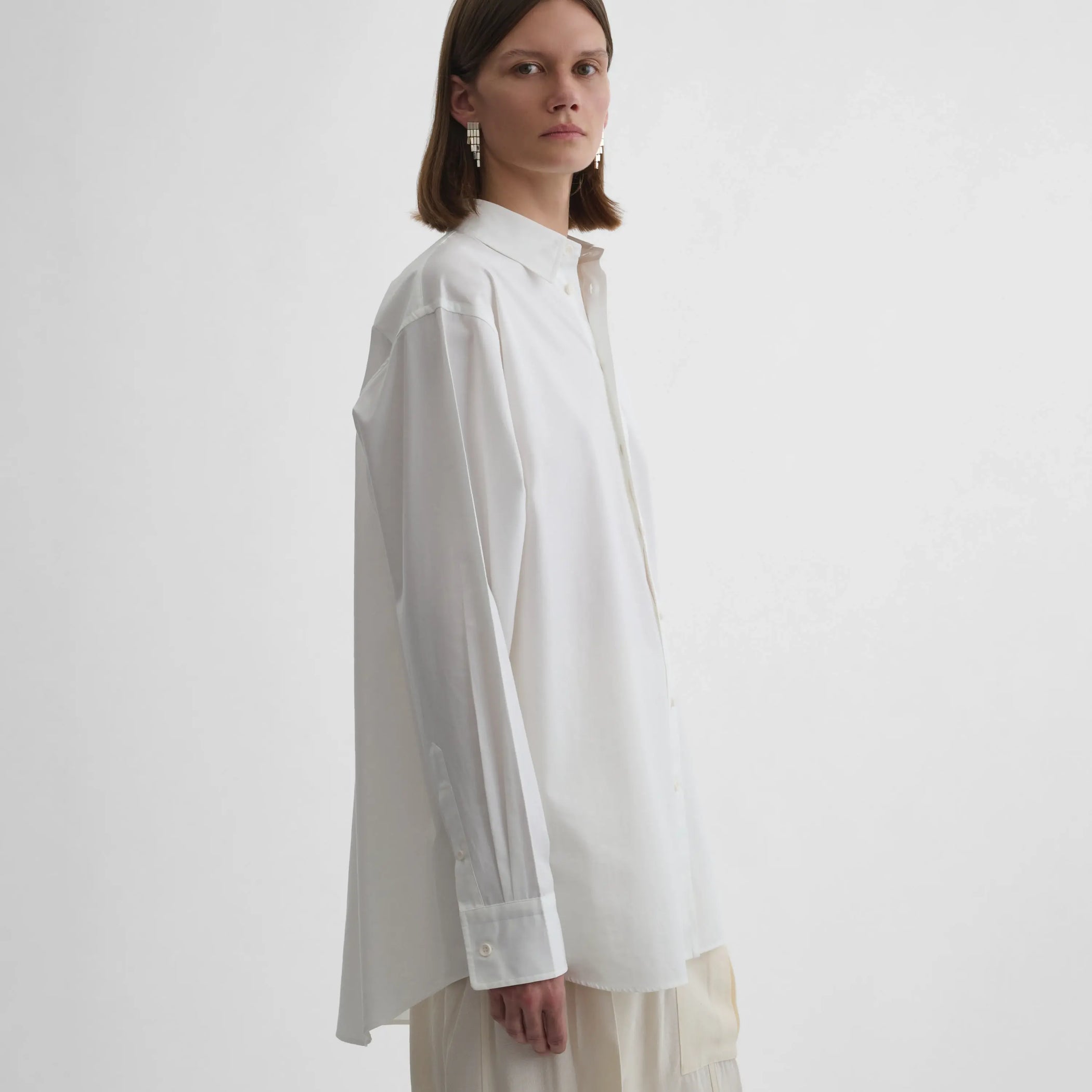 Side view of model wearing Sharp Collar Shirt in white.