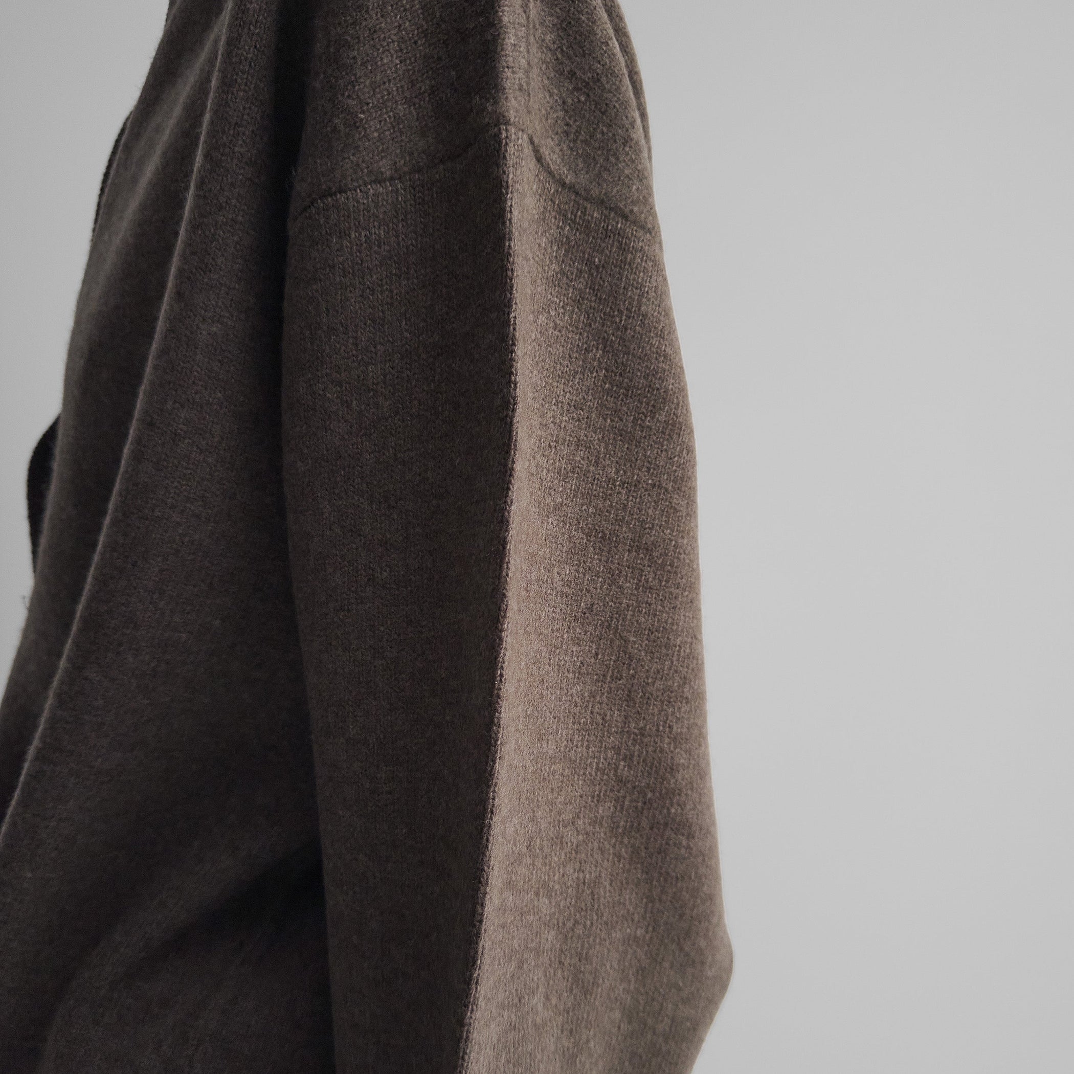 Detail view of model wearing SOFT SHIRT COLLAR JUMPER in dun