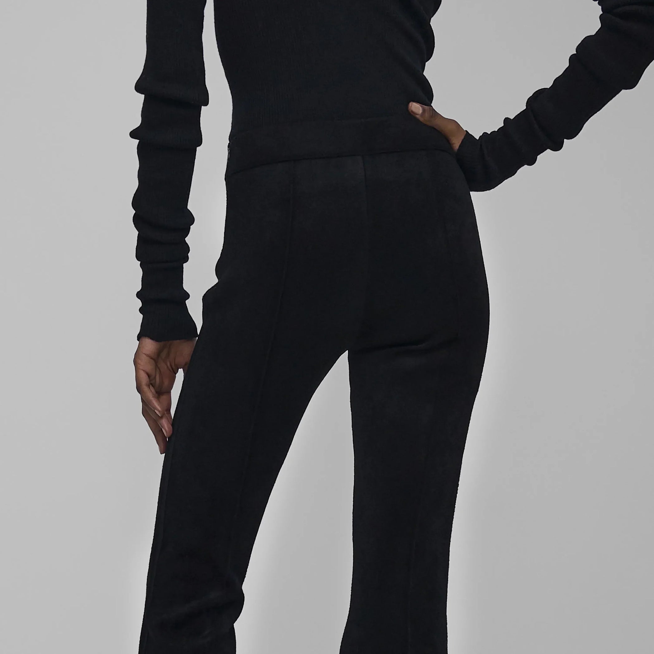Close up back view of model wearing CHENILLE TROUSERS in black technical polyester