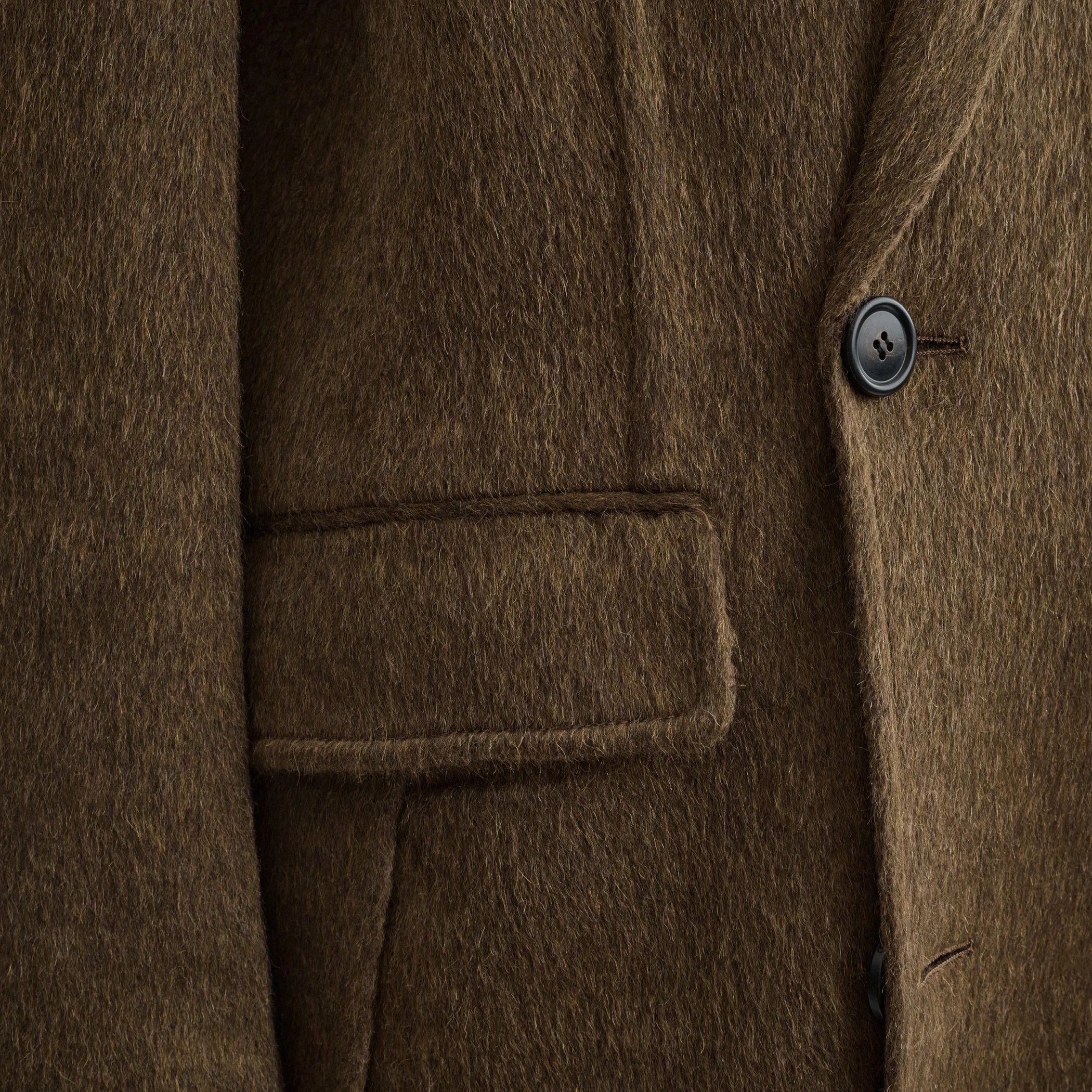 Back view of model wearing man&#39;s coat in bronze khaki wool mohair.