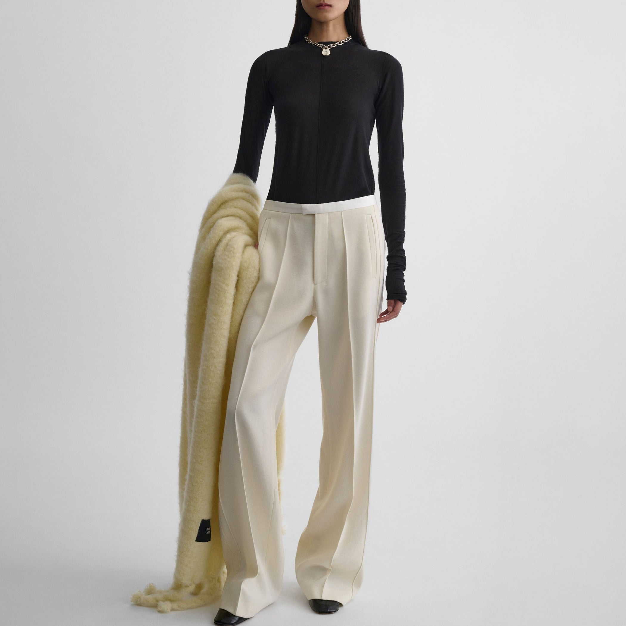 Front view of model wearing CLASSIC TAILORED TROUSERS in cream wool