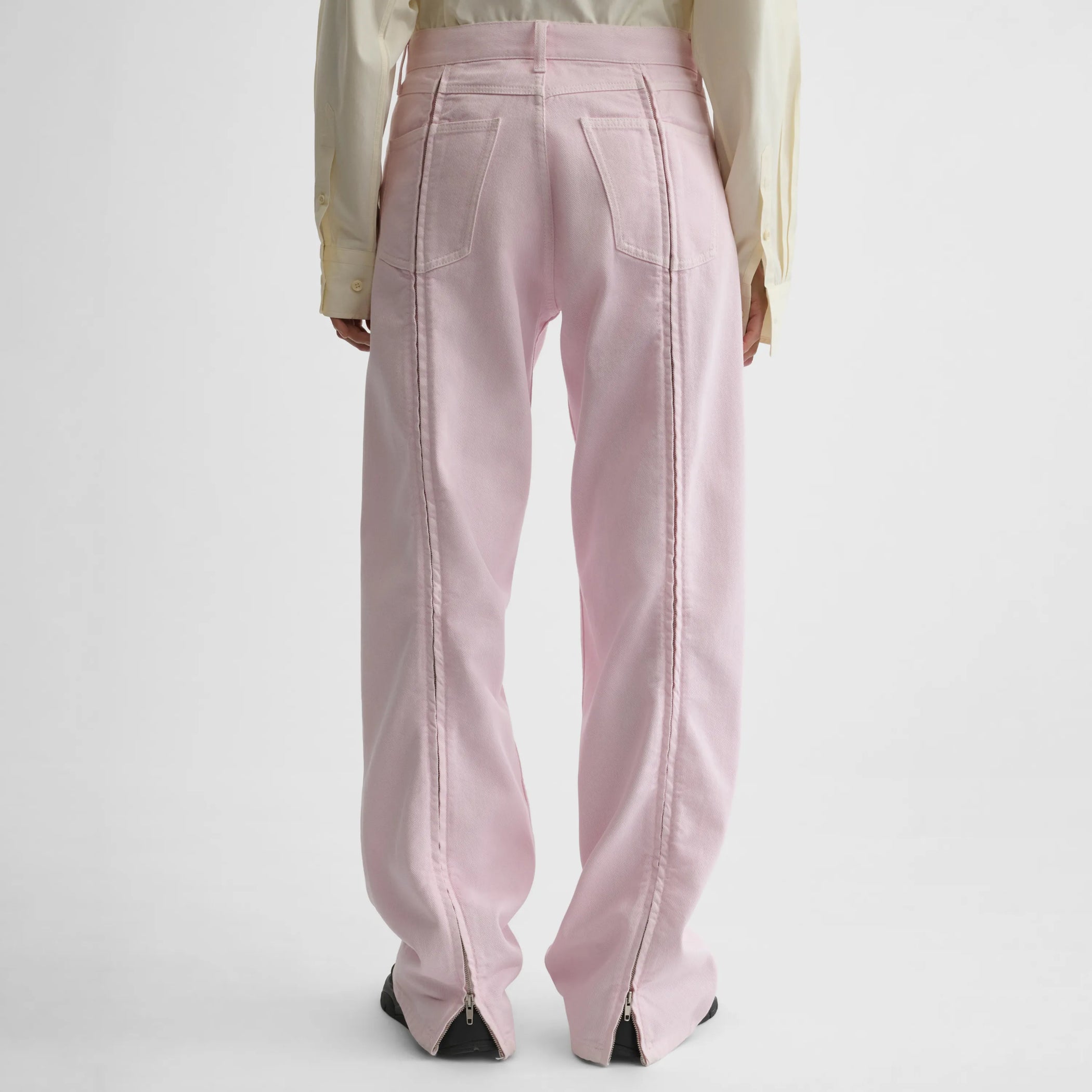 Back view of zip jeans in pale pink cotton