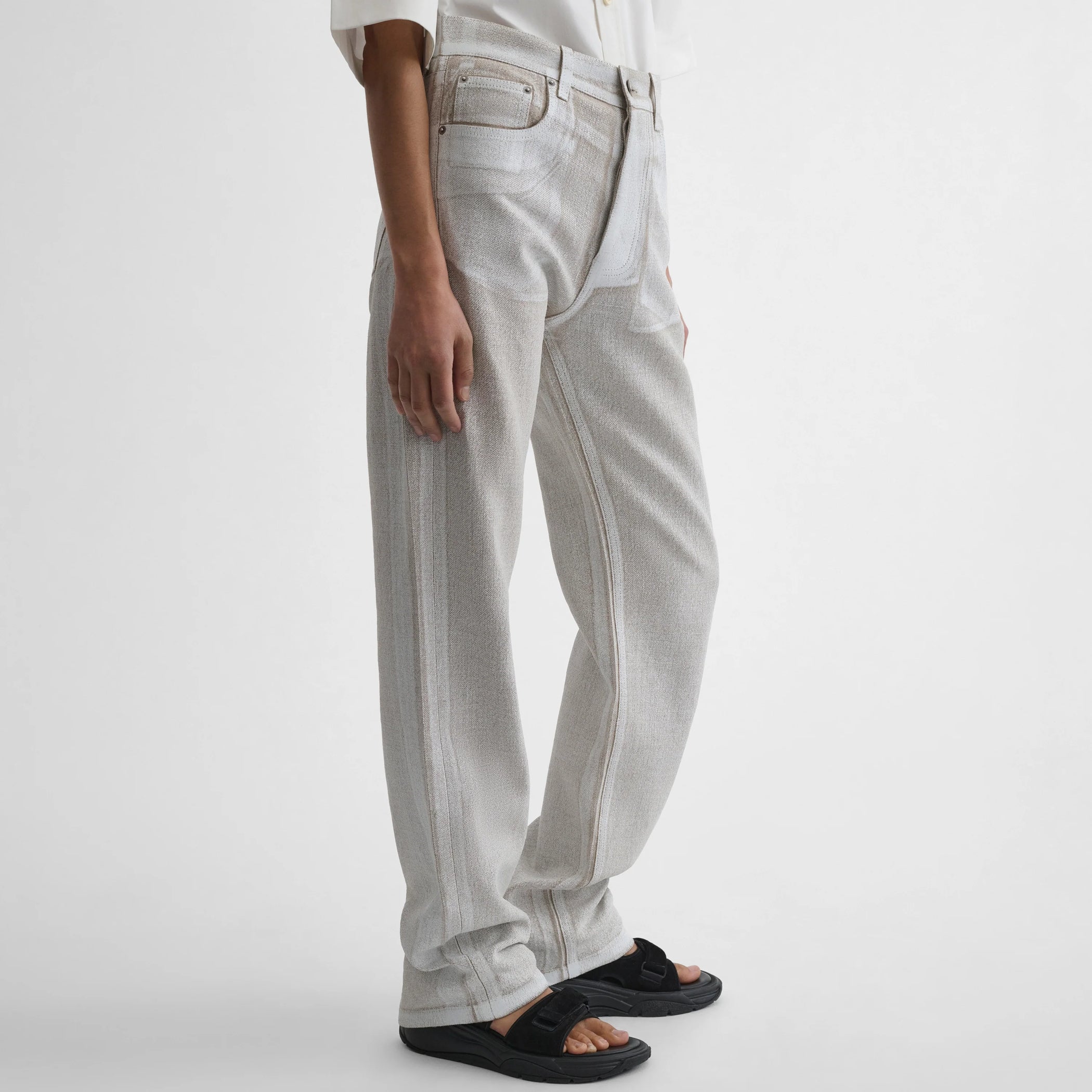 Side view of model wearing the classic jeans in hay
