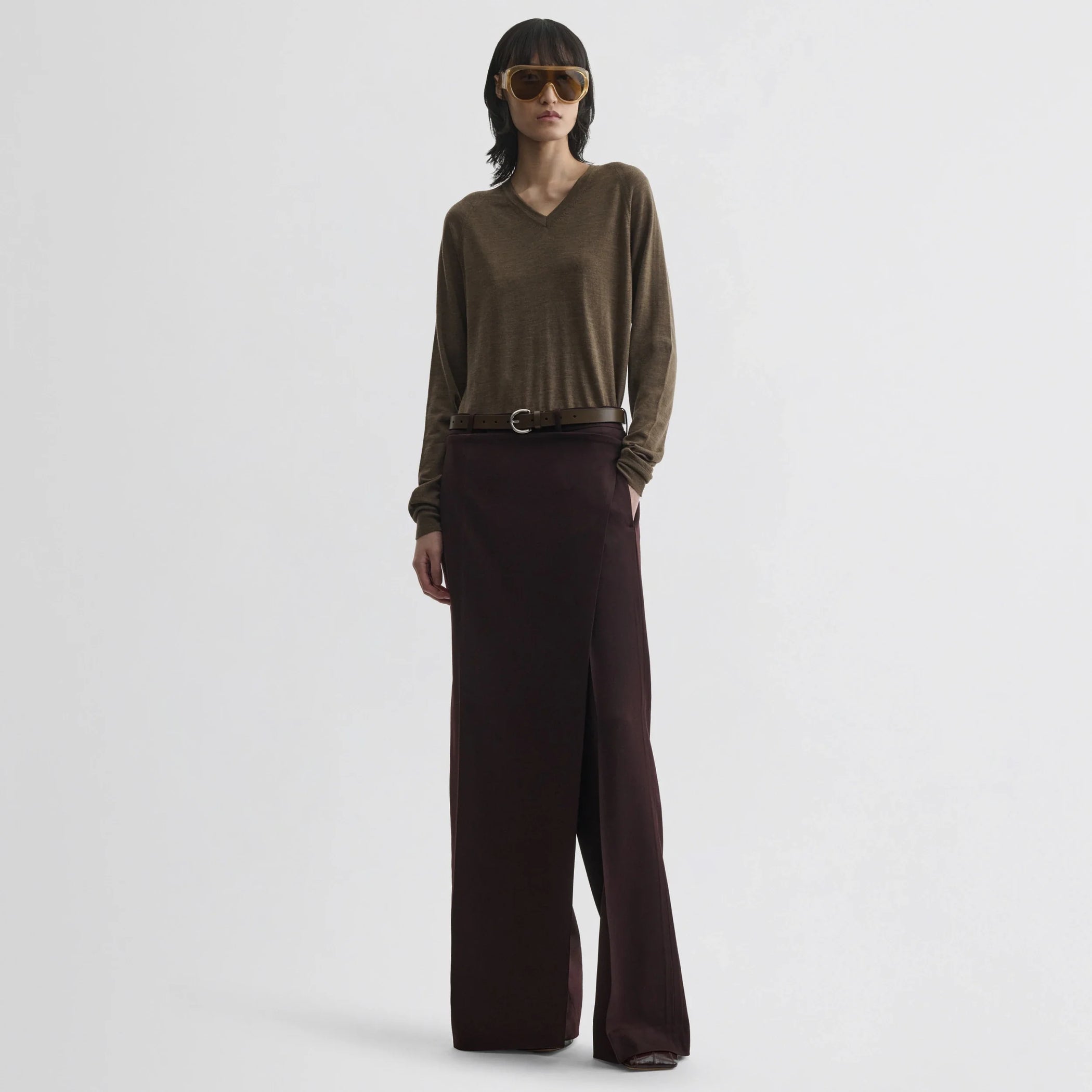 Front view of model wearing apron trousers in chocolate wool.