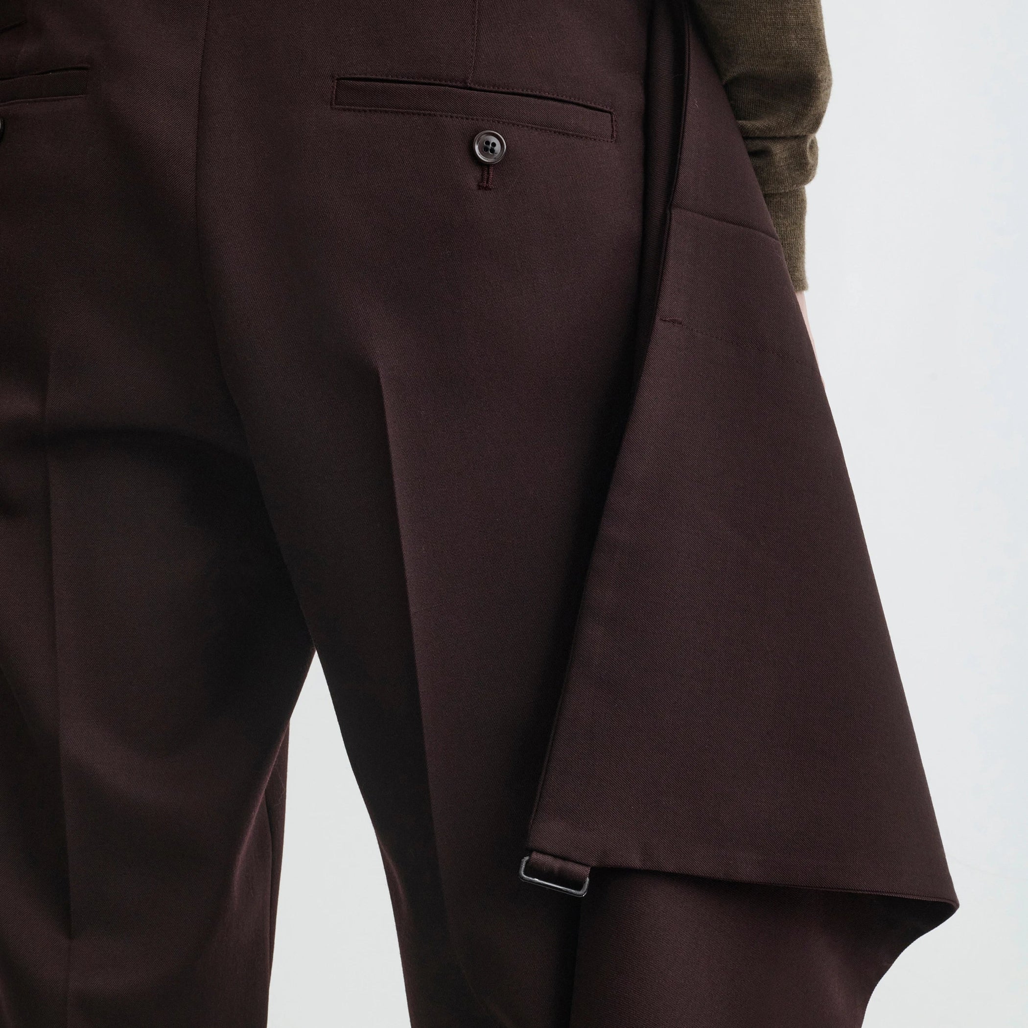 Close up detail view of apron trousers in chocolate wool.