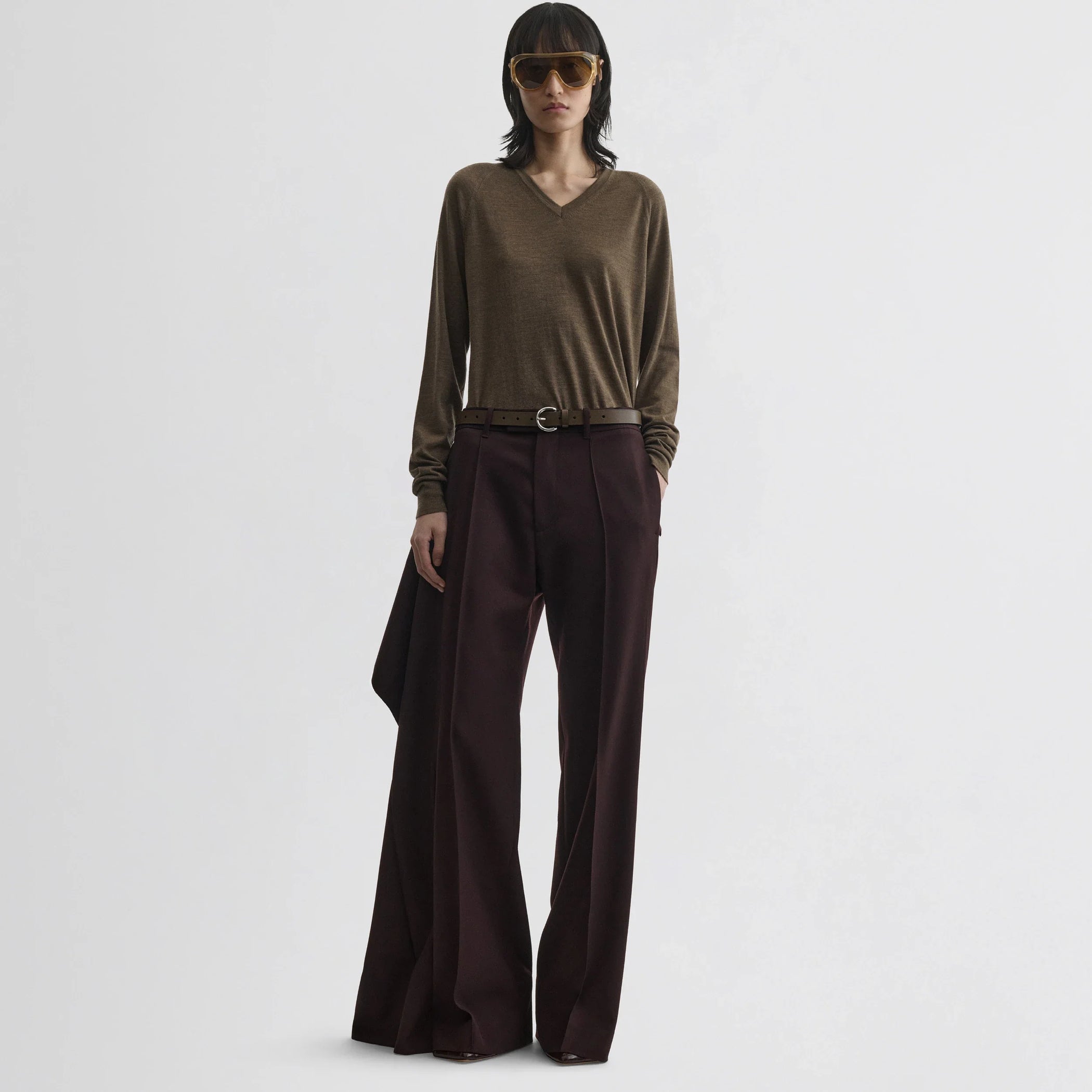 Front view of model wearing apron trousers in chocolate wool.