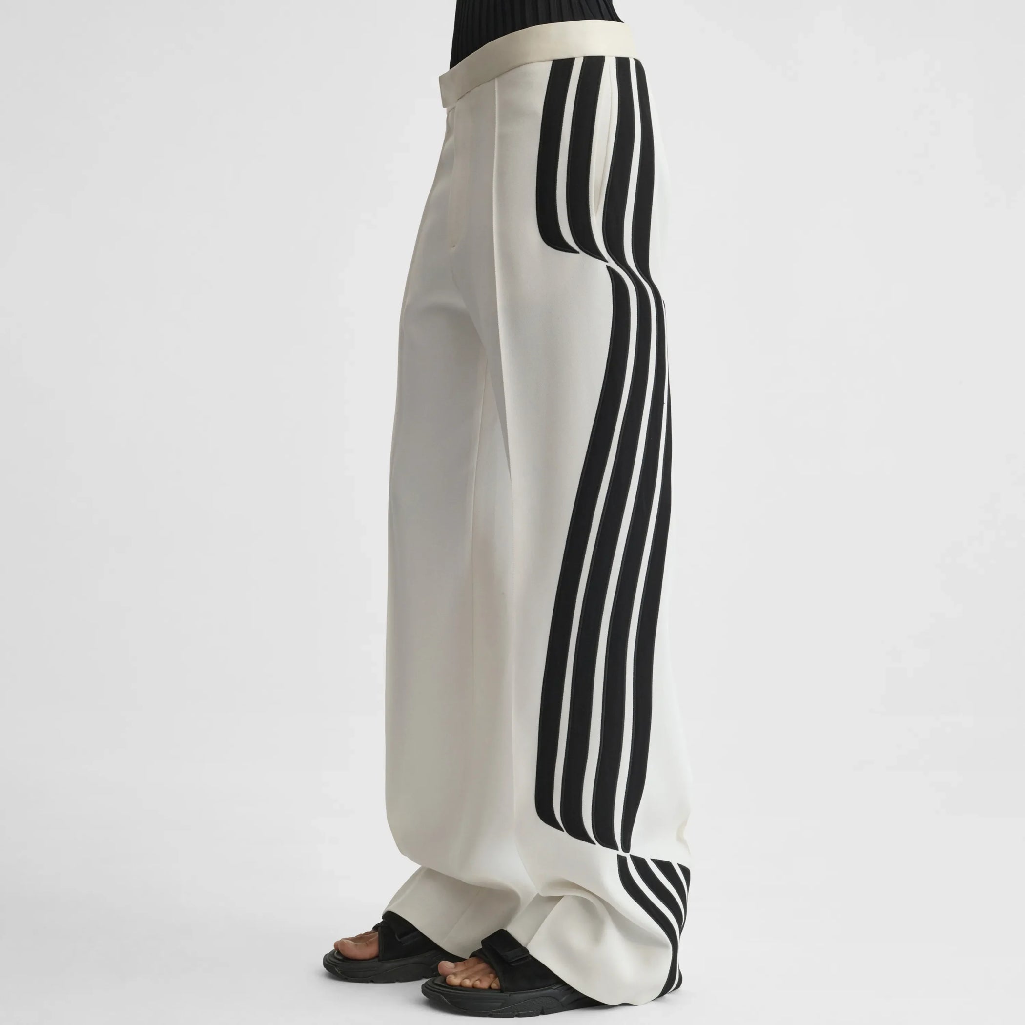 Side view of wave trousers in black and white technical tailoring