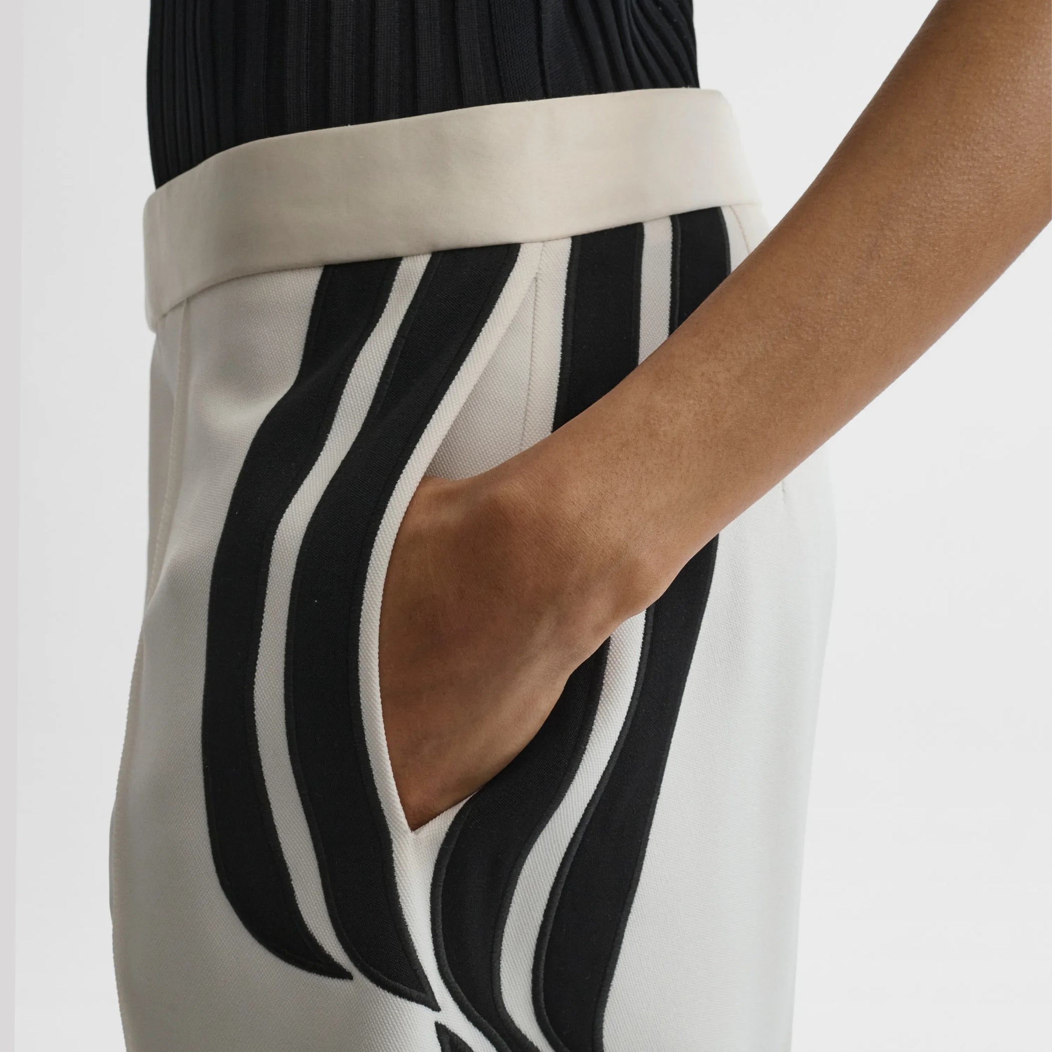 Close up detail view of wave trousers in black and white technical tailoring