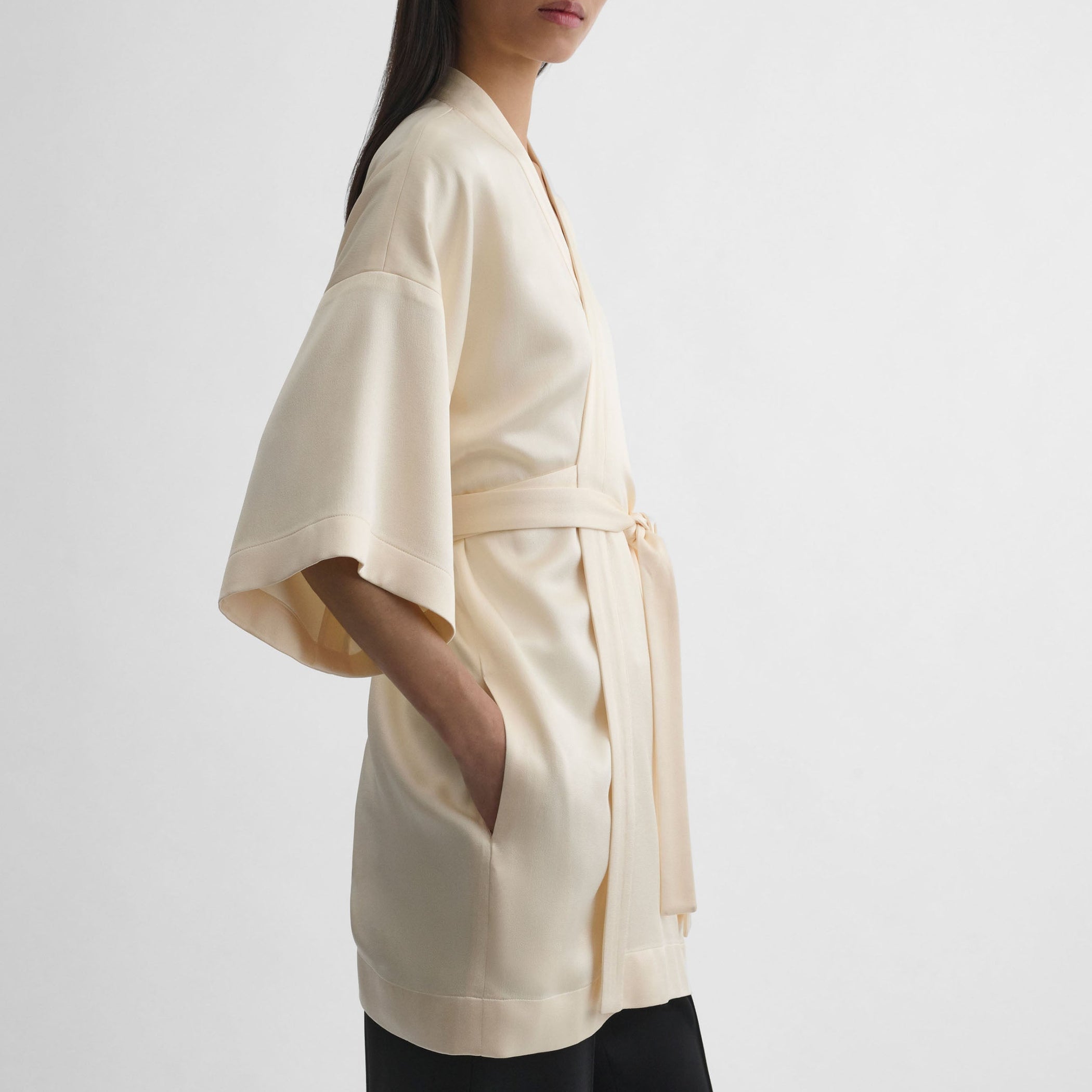 Side view of model wearing CROPPED ROBE DRESS in cream viscose