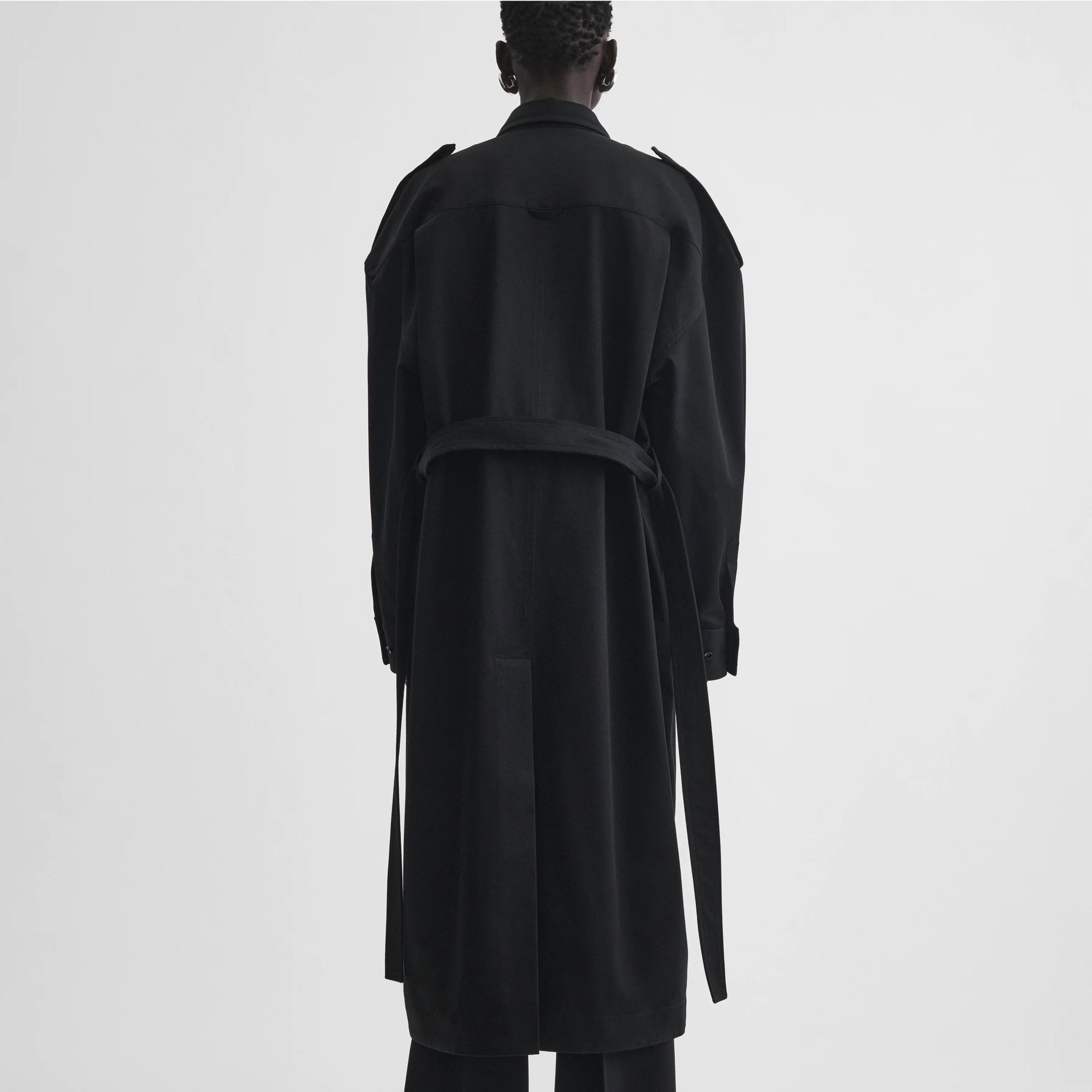 Back full body view of model wearing utility shirt dress in black cotton