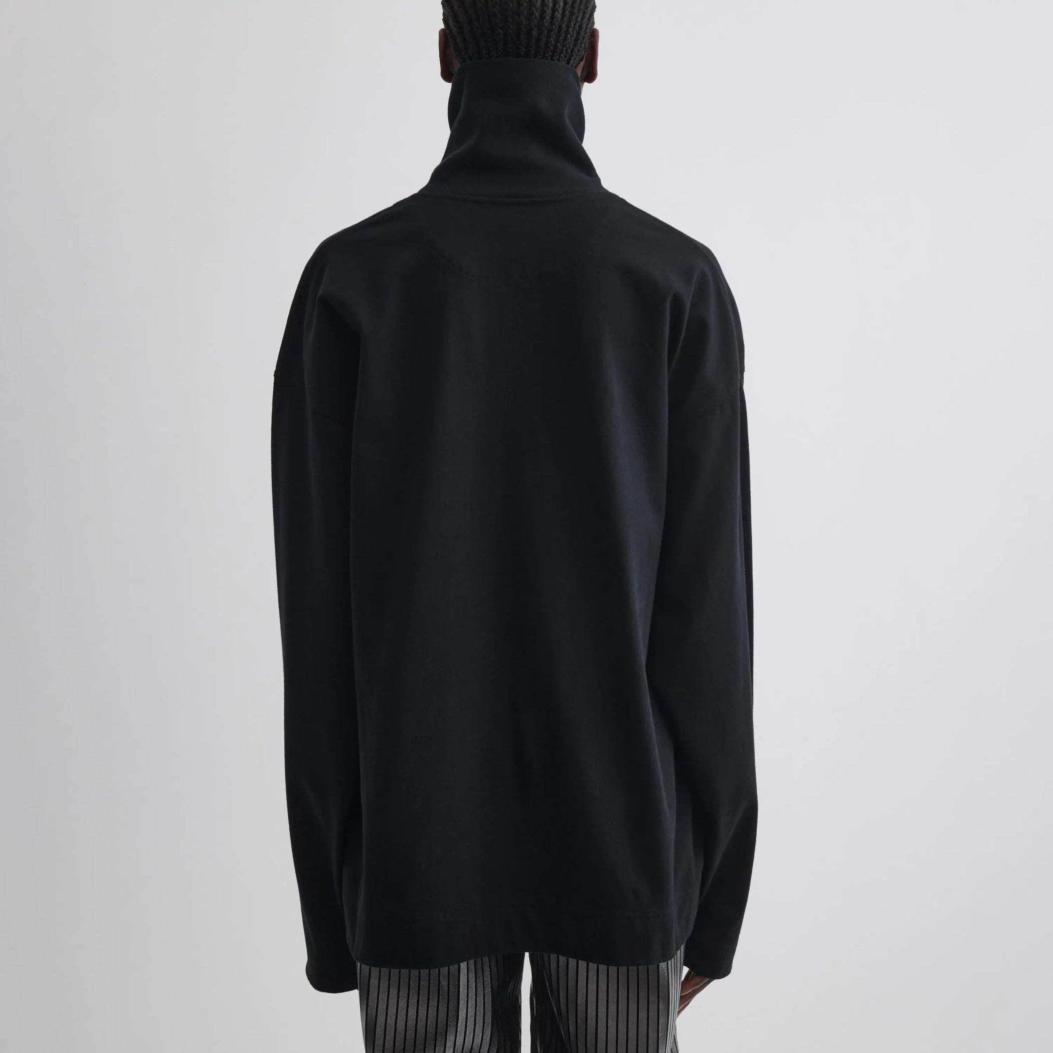 Back view of relaxed long sleeve jersey in black cotton jersey