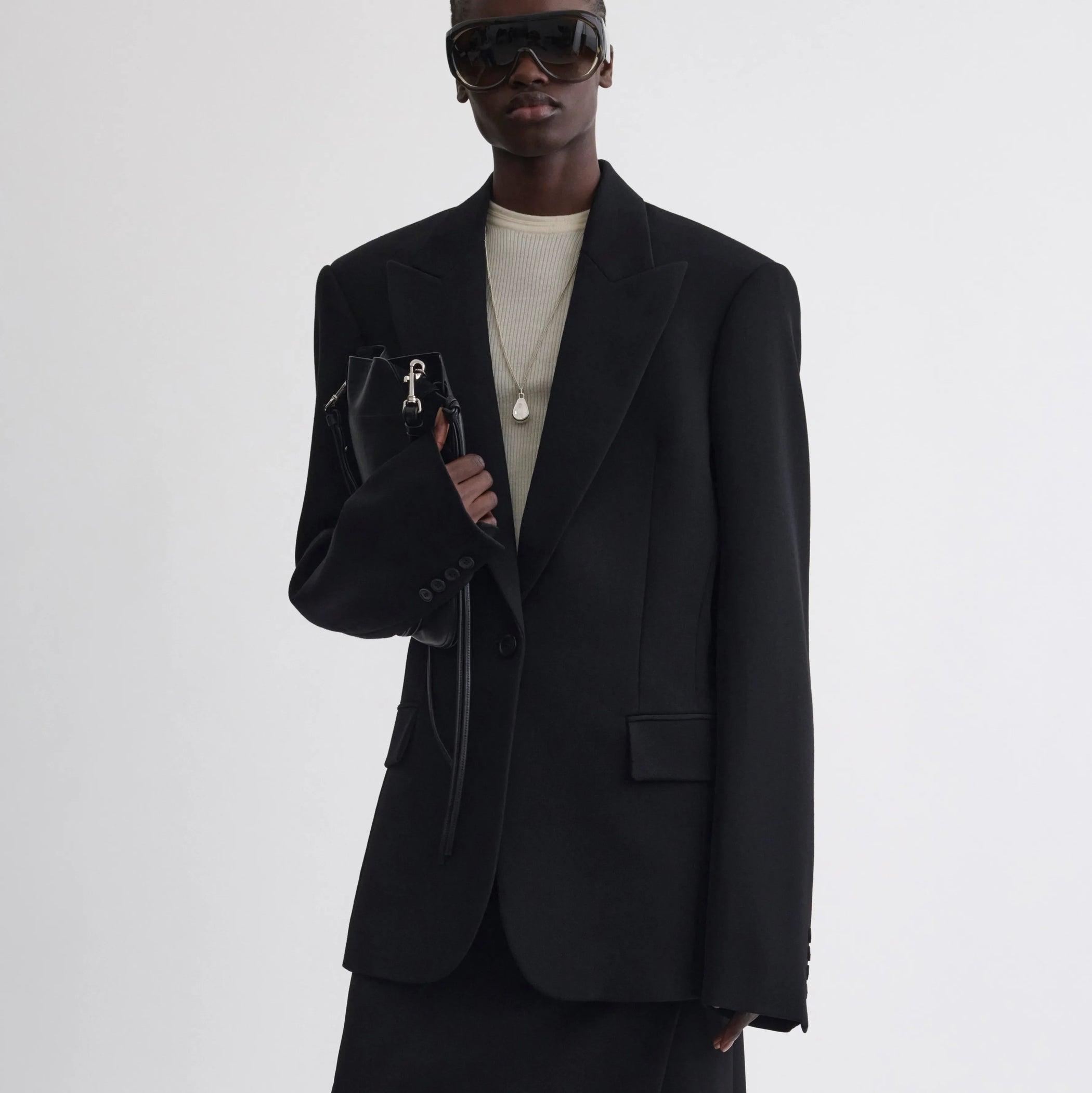 Front view of model wearing Single Breasted Tailored Jacket in black.