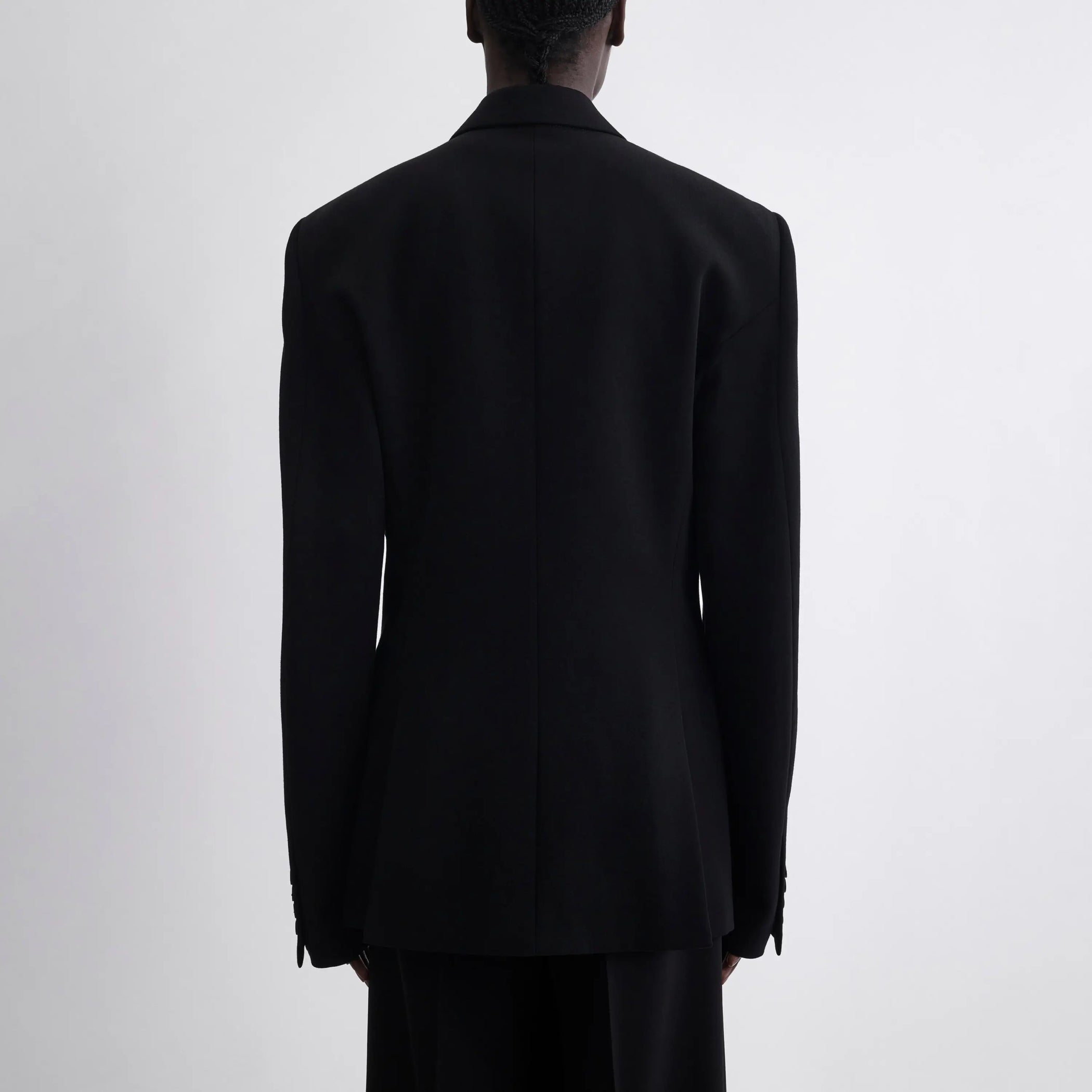 Back view of model wearing Single Breasted Tailored Jacket in black.