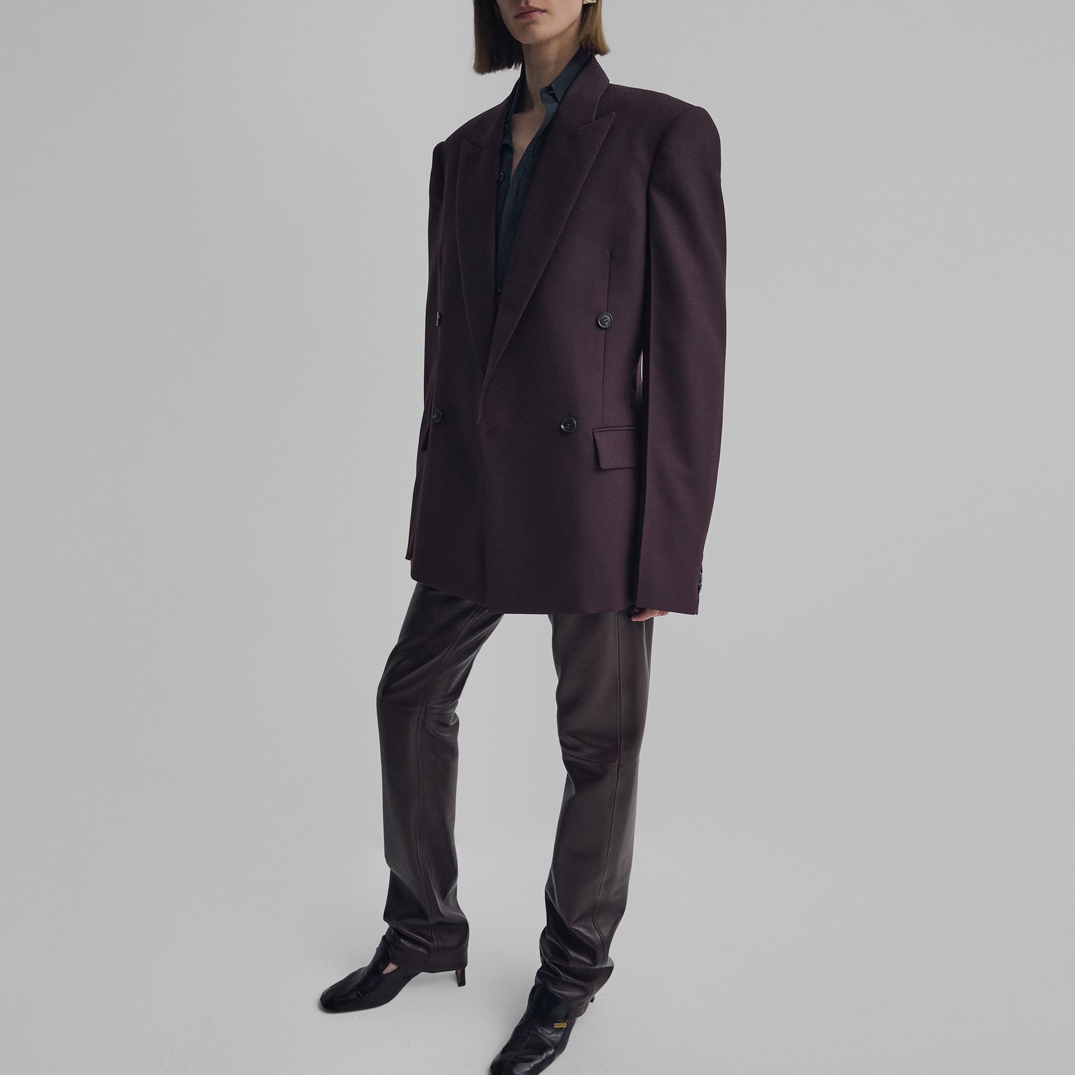 Angled front view of model wearing MILANESE JACKET in berry wool