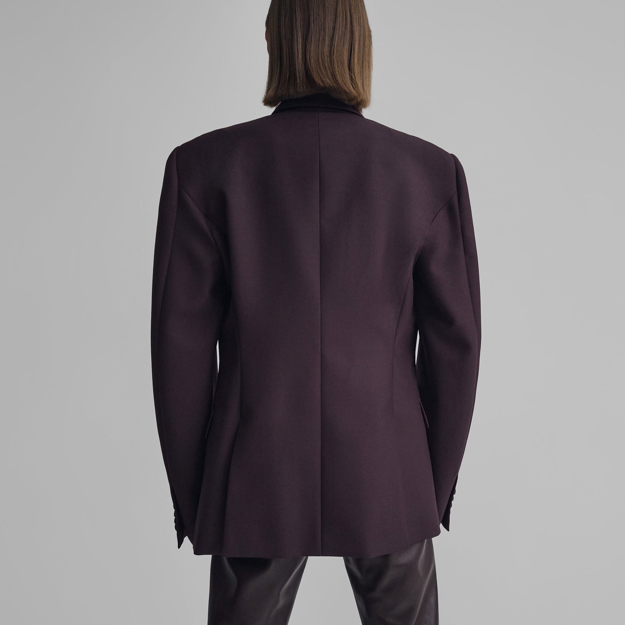 Back view of model wearing MILANESE JACKET in berry wool