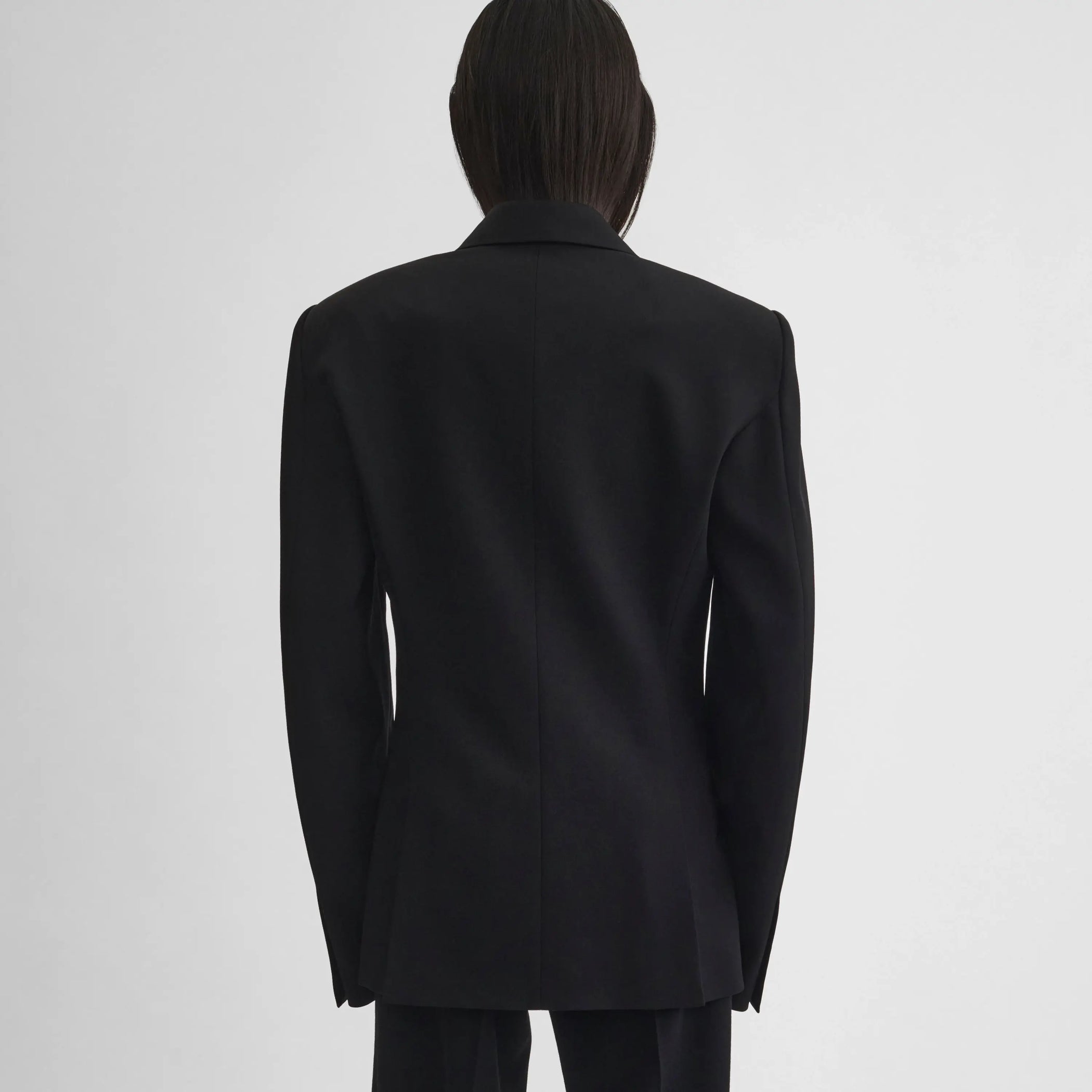Back view of model wearing Milanese Jacket in black.