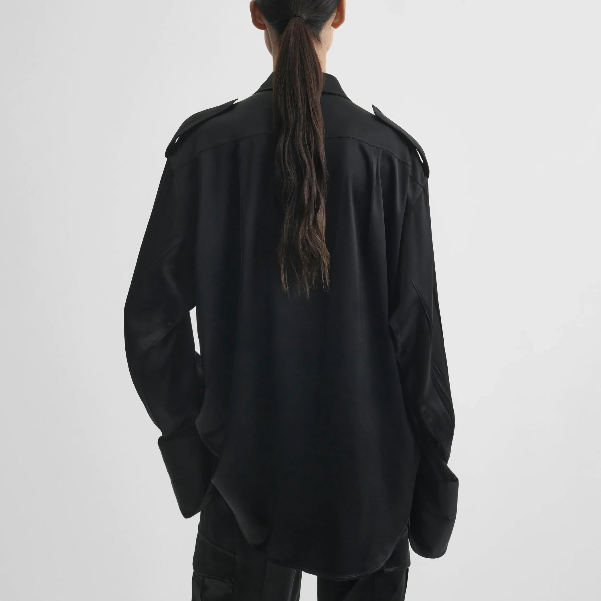 Back model view of liquid utility shirt in black silk satin