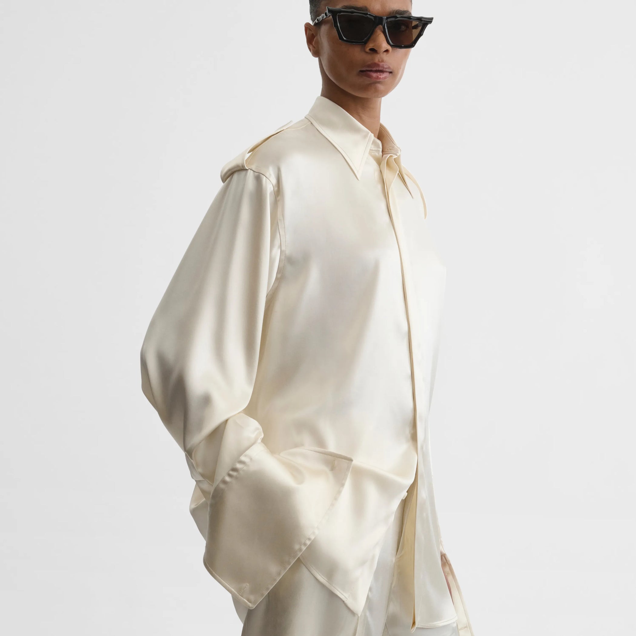 Side view of liquid utility shirt in cream silk