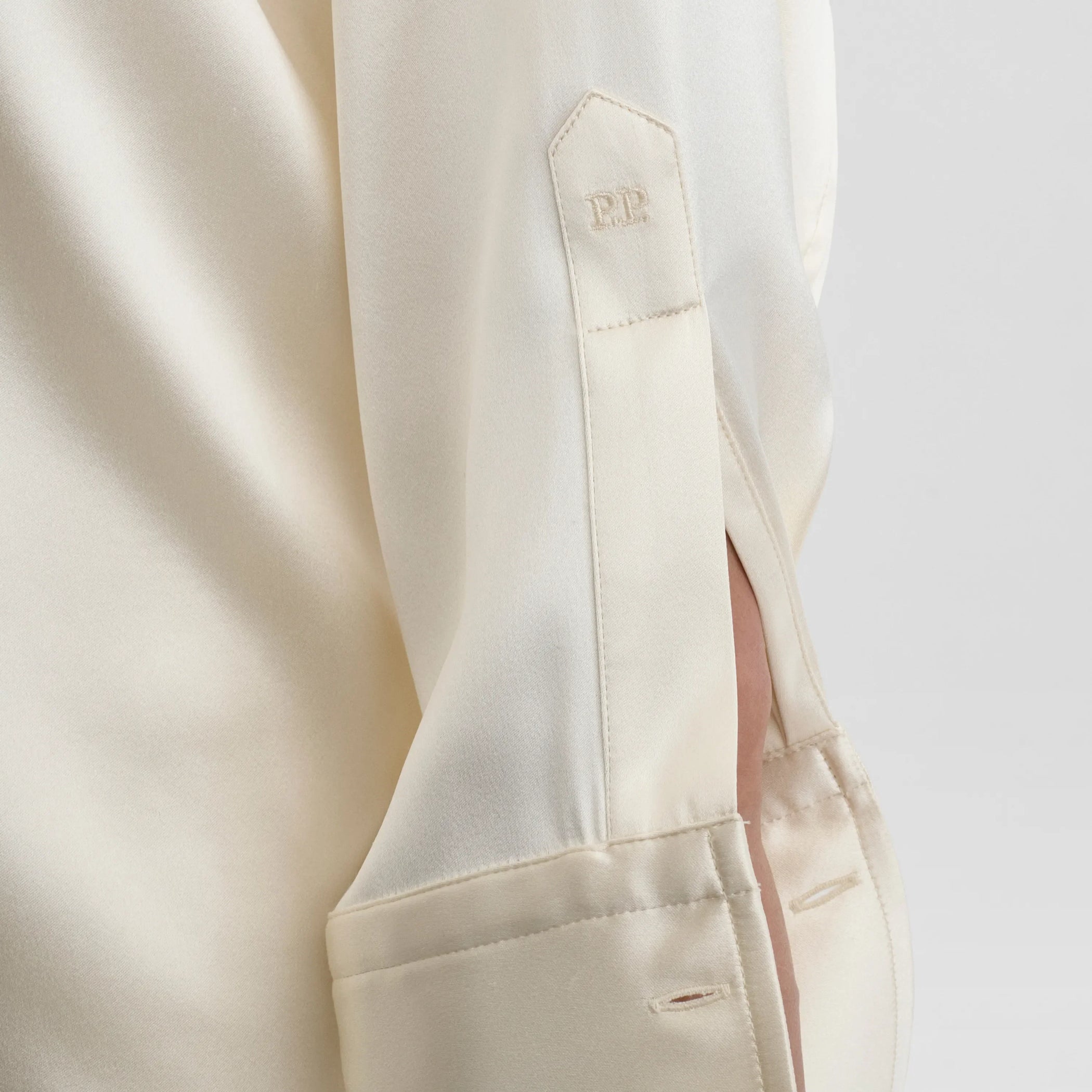 Close up detail view of liquid utility shirt in cream silk