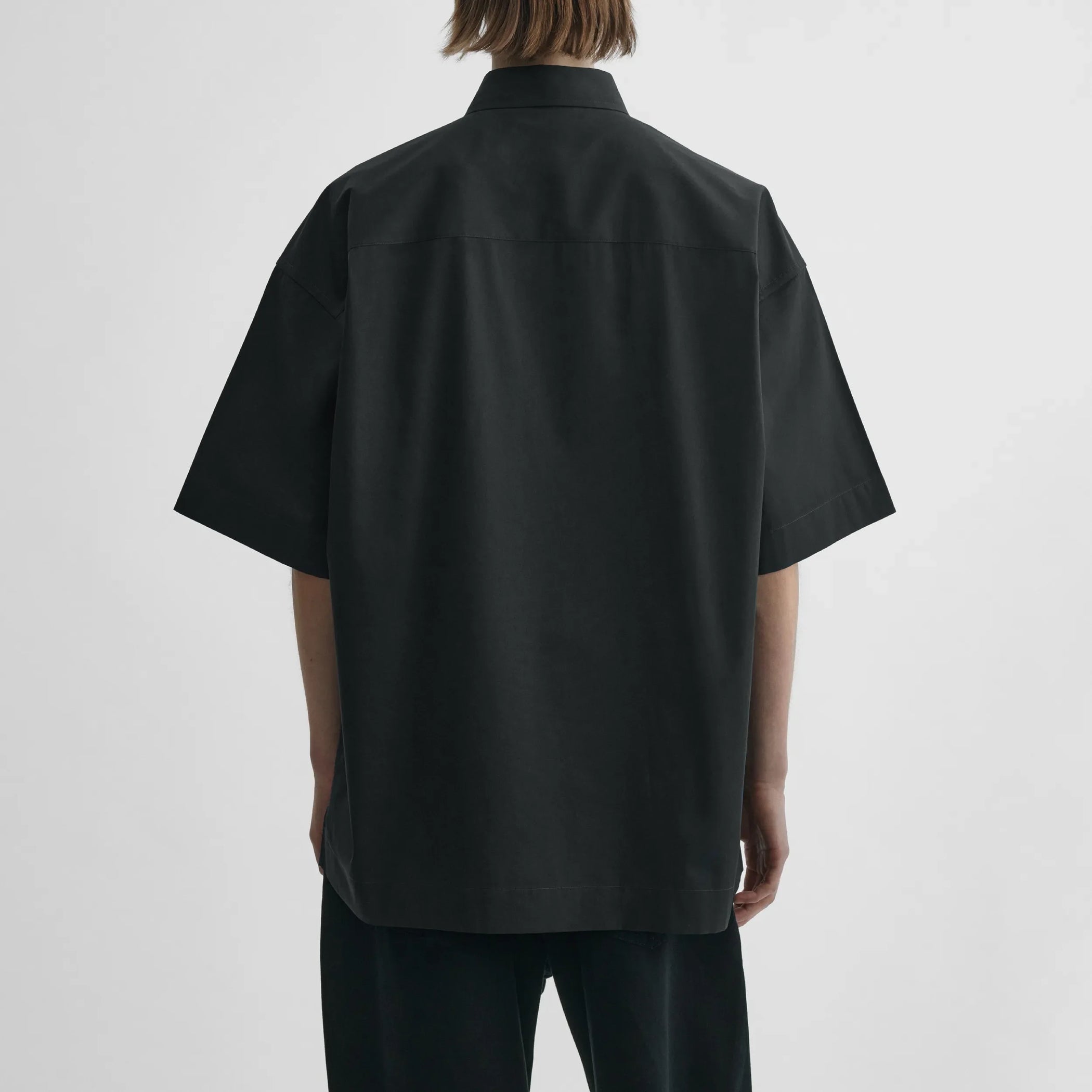Back view of short sleeve shirt in black cotton