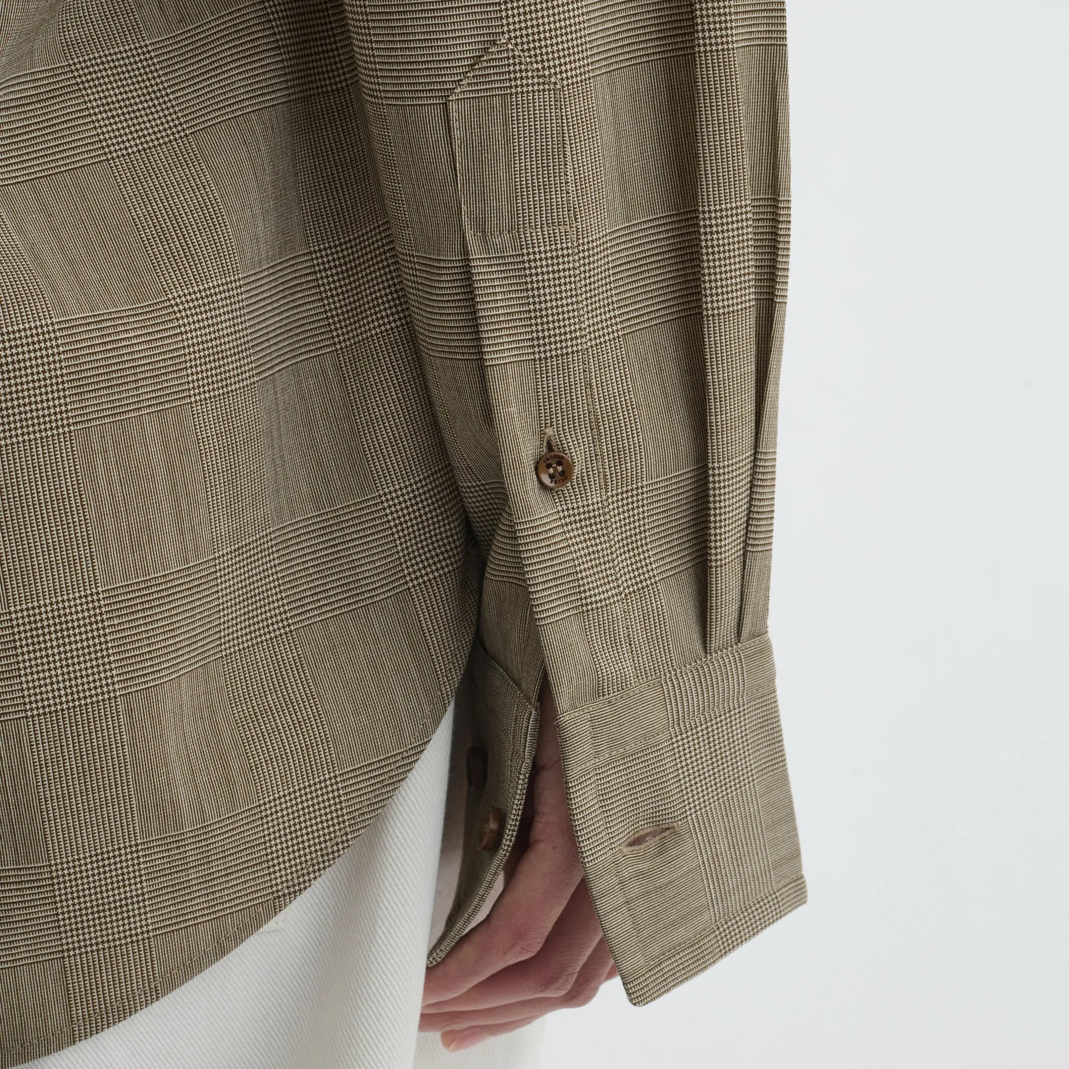 Close up detail view of classic shirt in brown-beige wool
