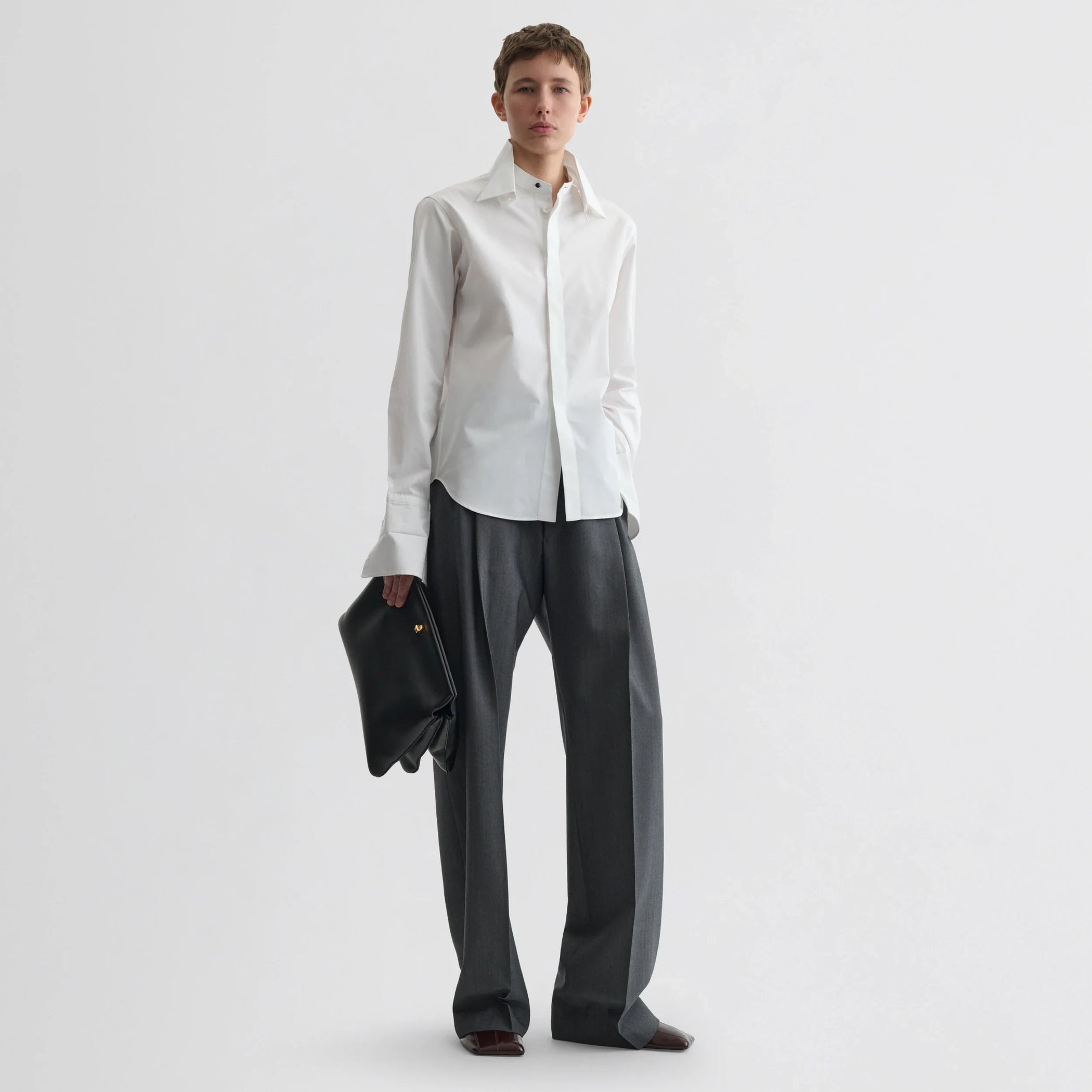 Front view of model wearing tuxedo shirt in white cotton.