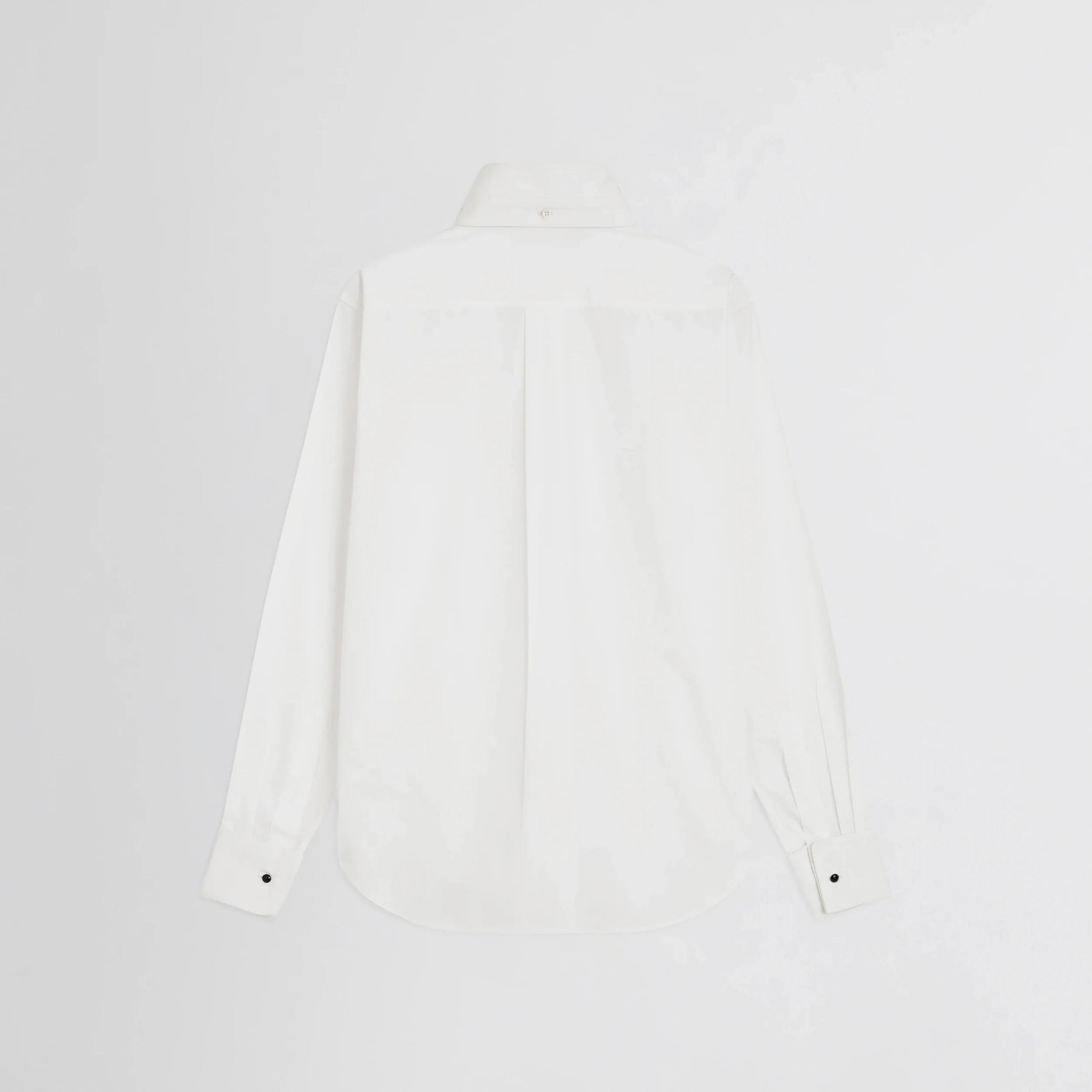 Flat back view of tuxedo shirt in white cotton.