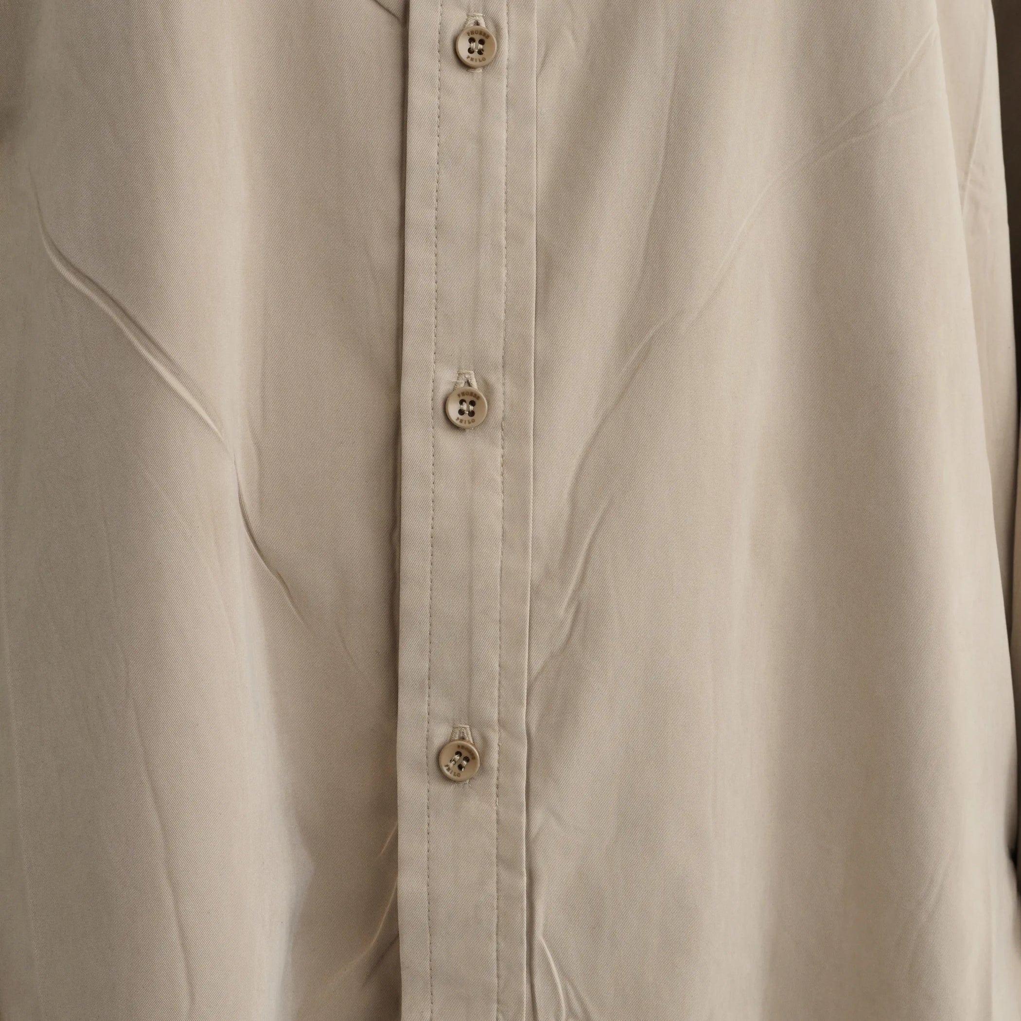 Close up detail view of elongated shirt in trench cotton