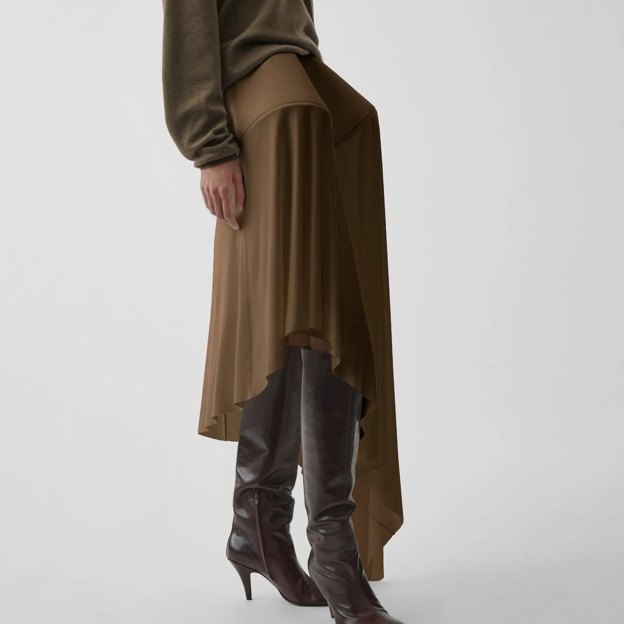 Side view of sculptural skirt in toffee jersey.