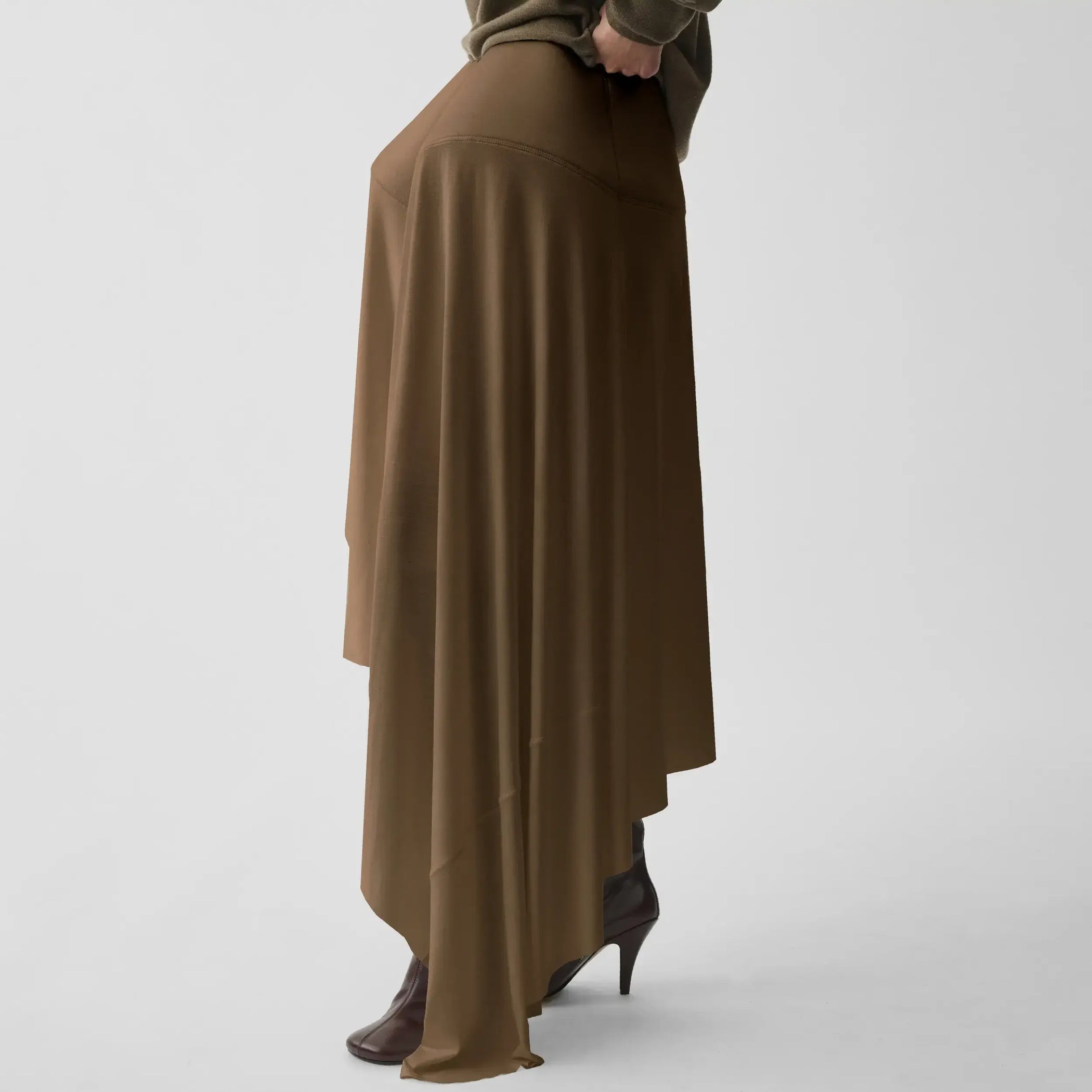 Side view of sculptural skirt in toffee jersey.