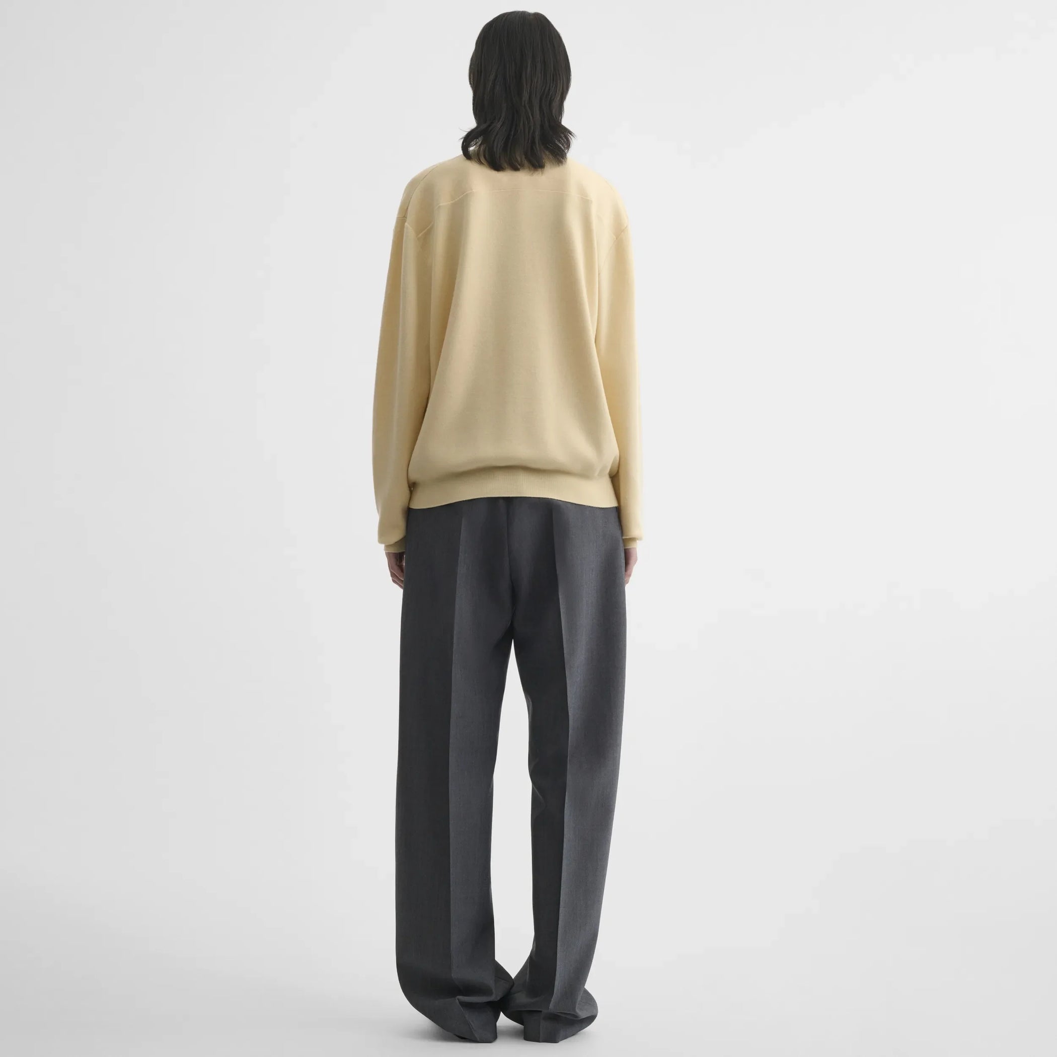 Back view of zip polo in pastel-yellow wool
