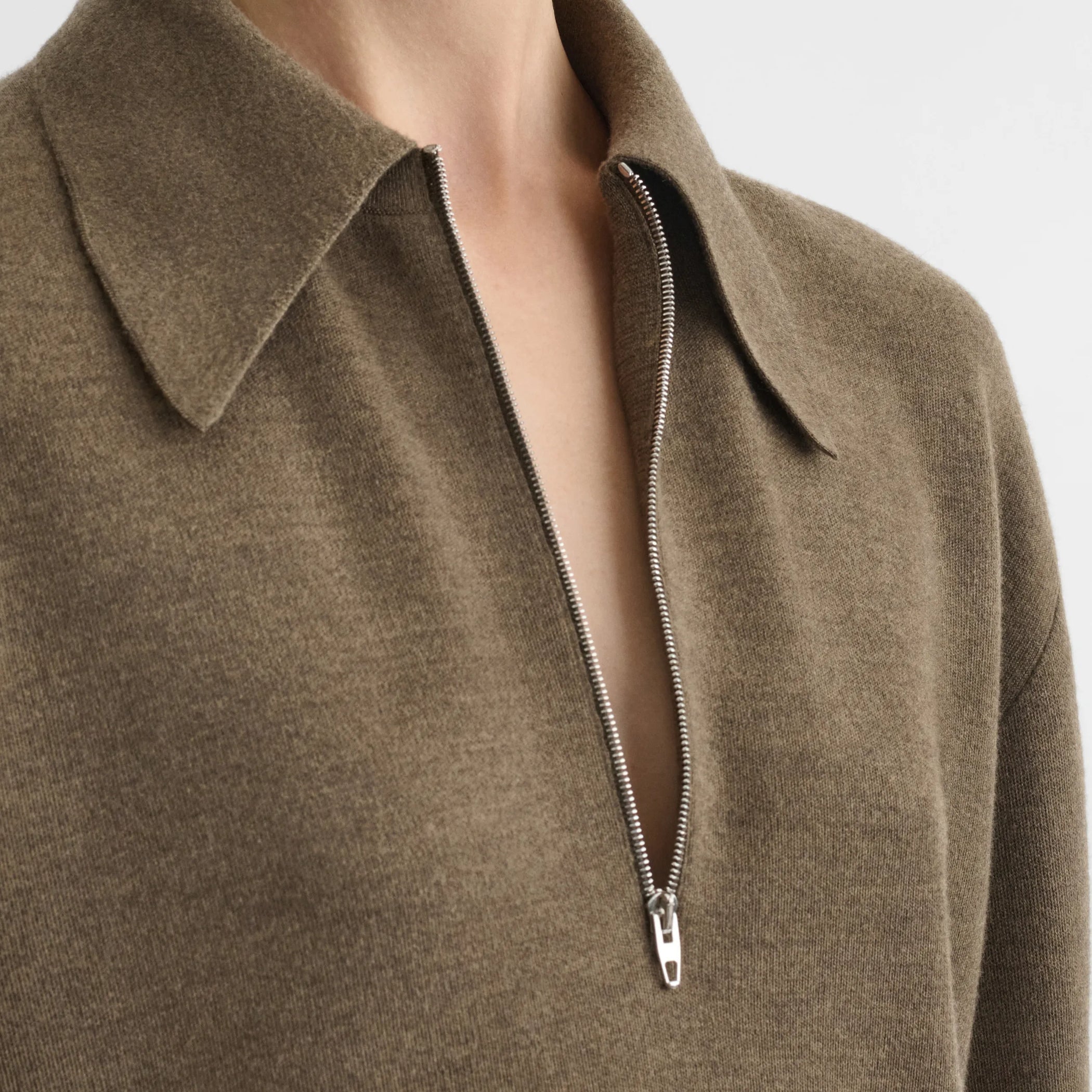 Close up detail view of zip polo in taupe-melange wool