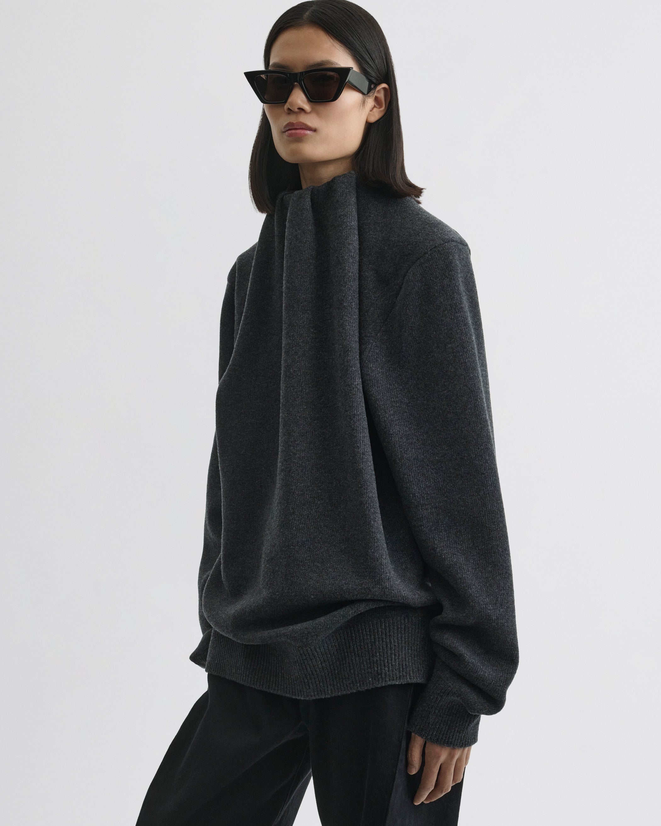 Side view of model wearing SOFT RIDGE JUMPER in grey melange wool
