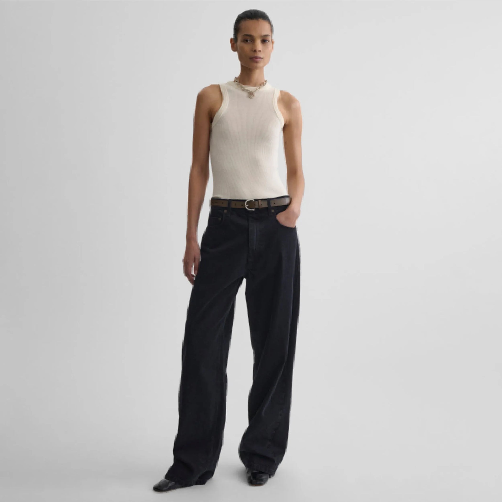 Front view model wearing light merino wool rib tank top in cream
