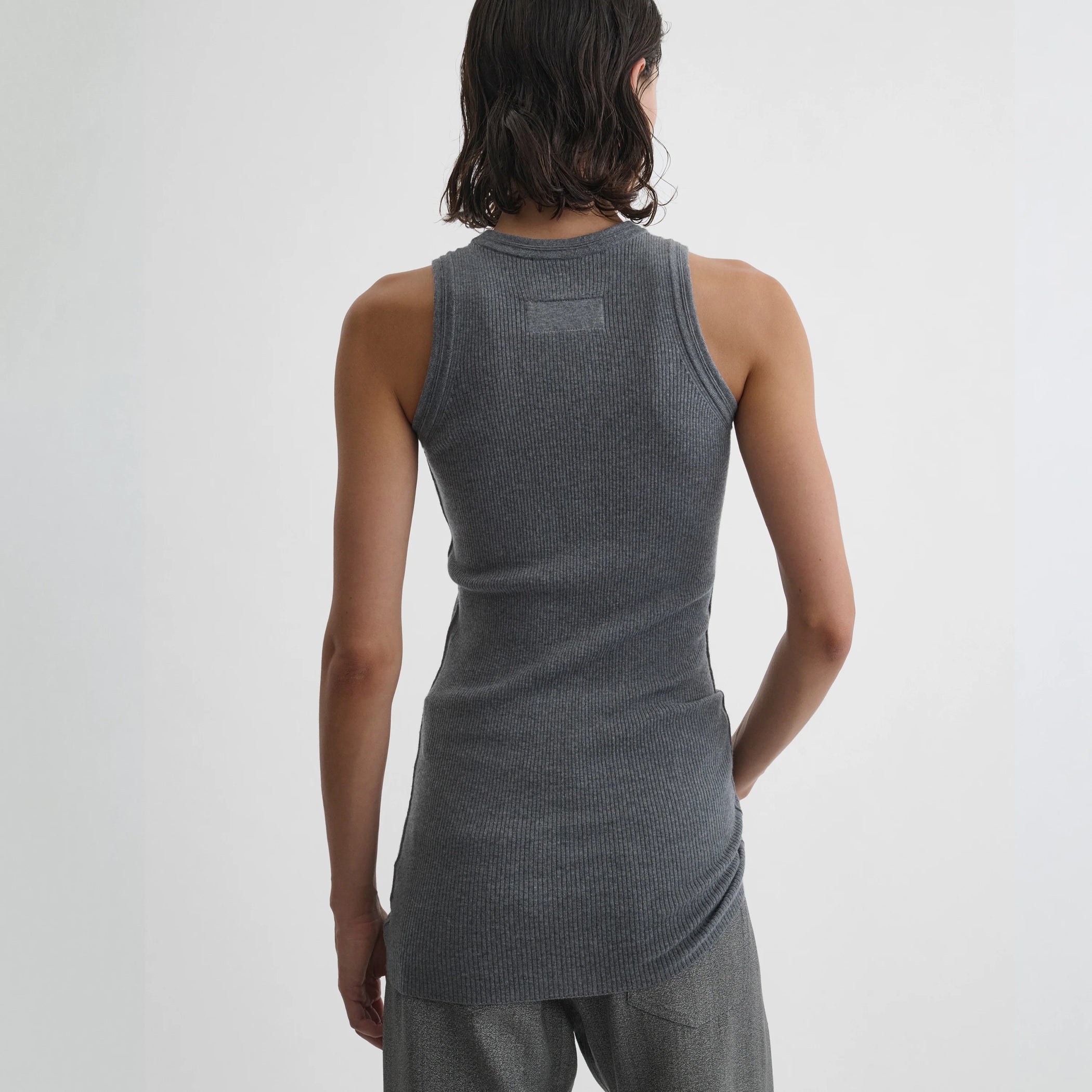 Back view of model wearing ribbed tank in grey wool