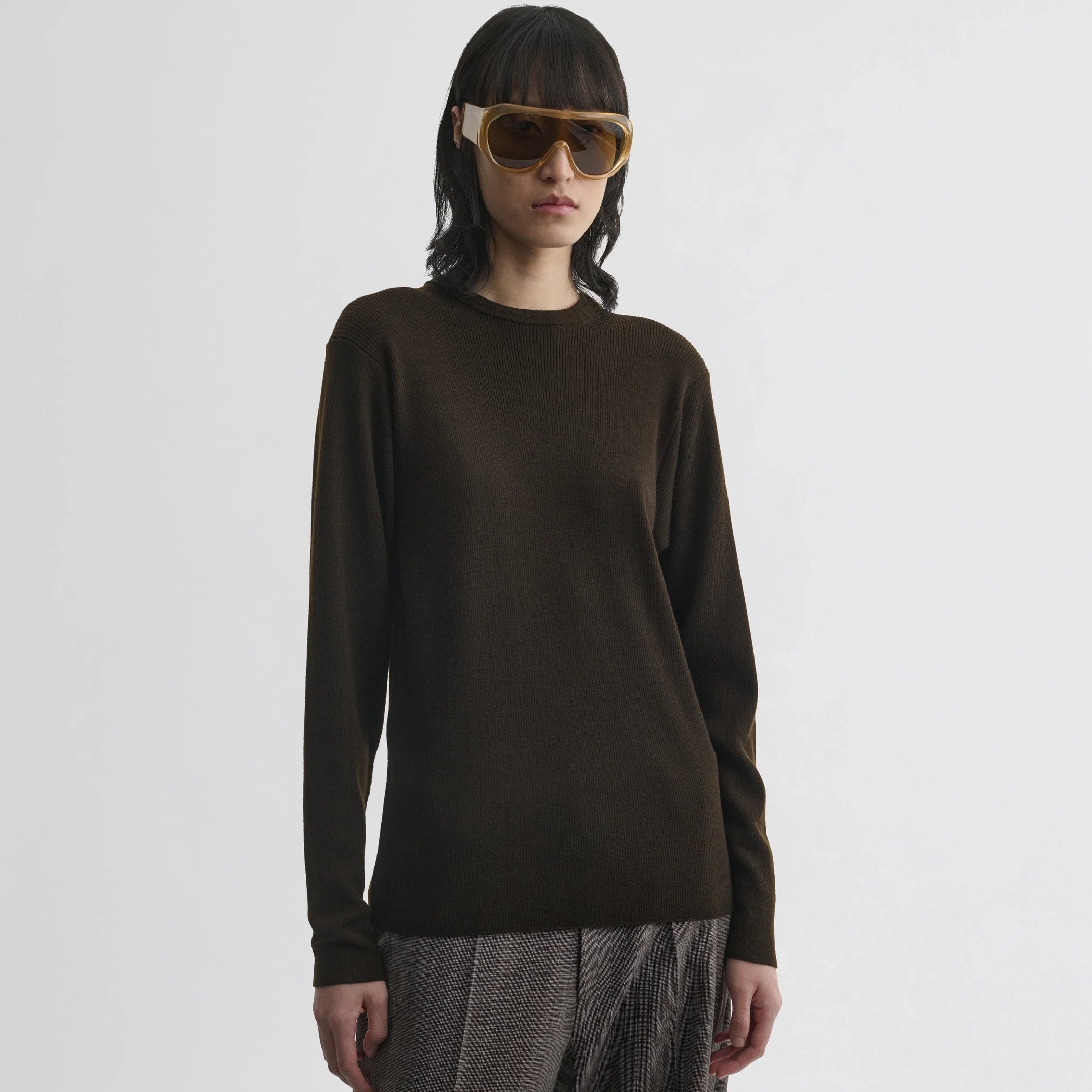 Front view of model wearing batwing crewneck in dark khaki wool.