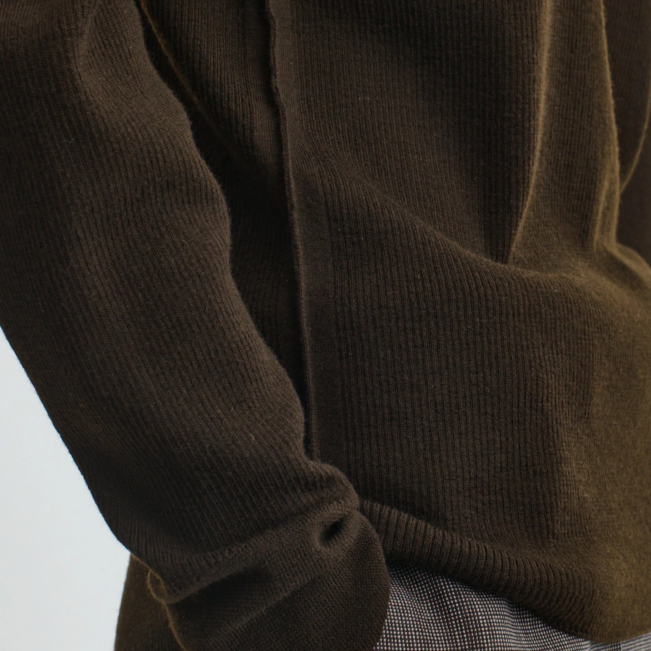 Close up detail view of batwing crewneck in dark khaki wool.