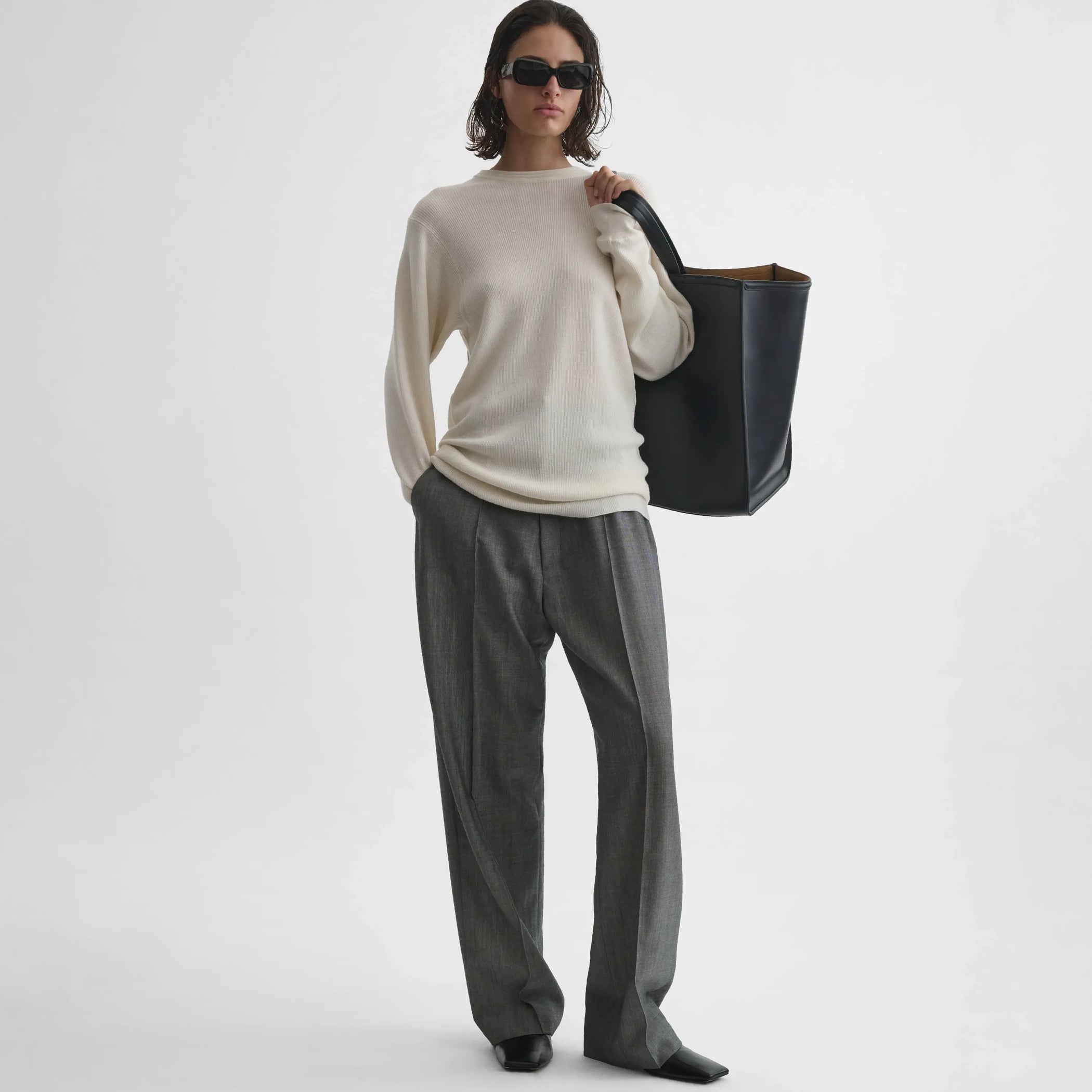 Full body front view of model wearing Ribbed Long Sleeve Crewneck in cream.