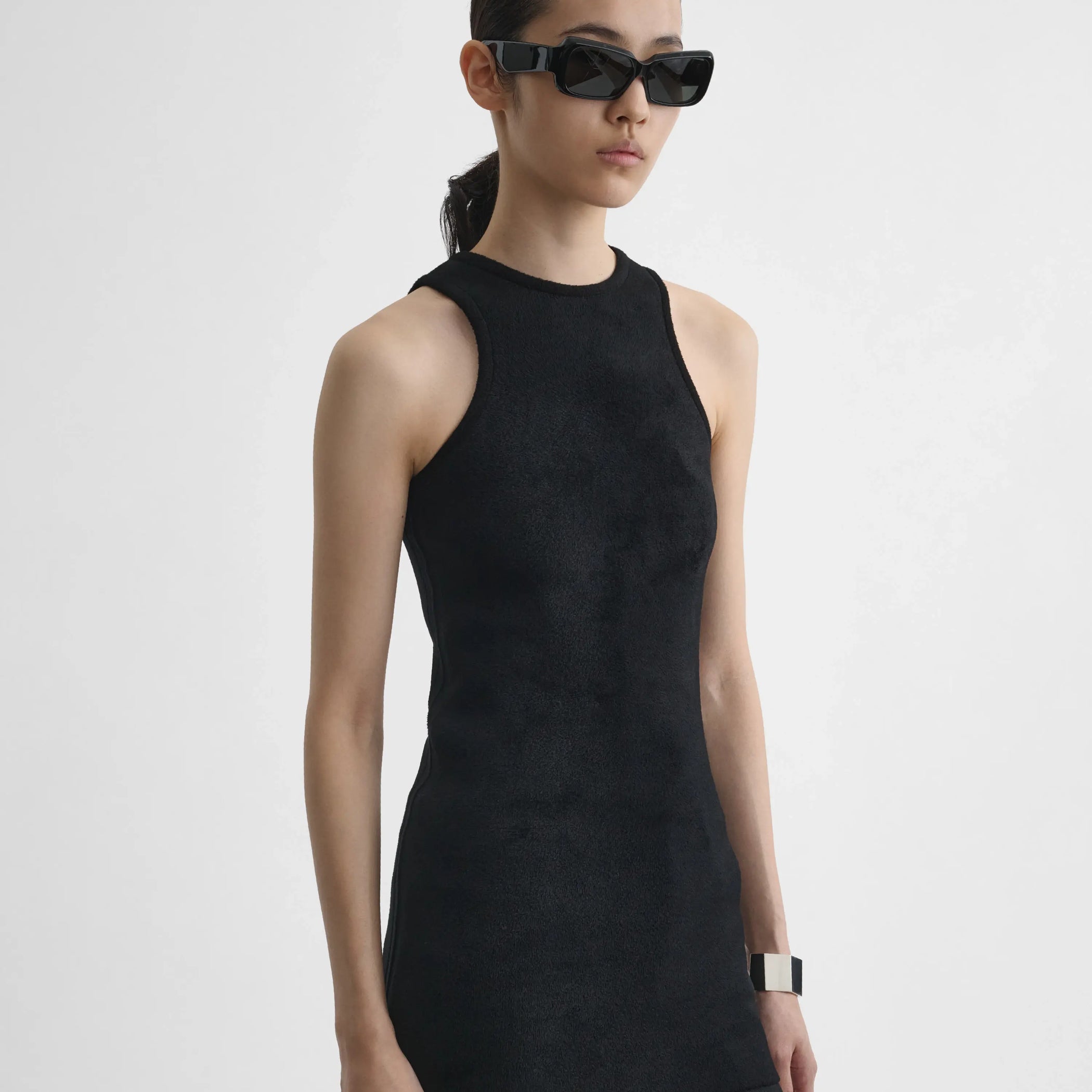 Angled view of model wearing Tank Top in black.