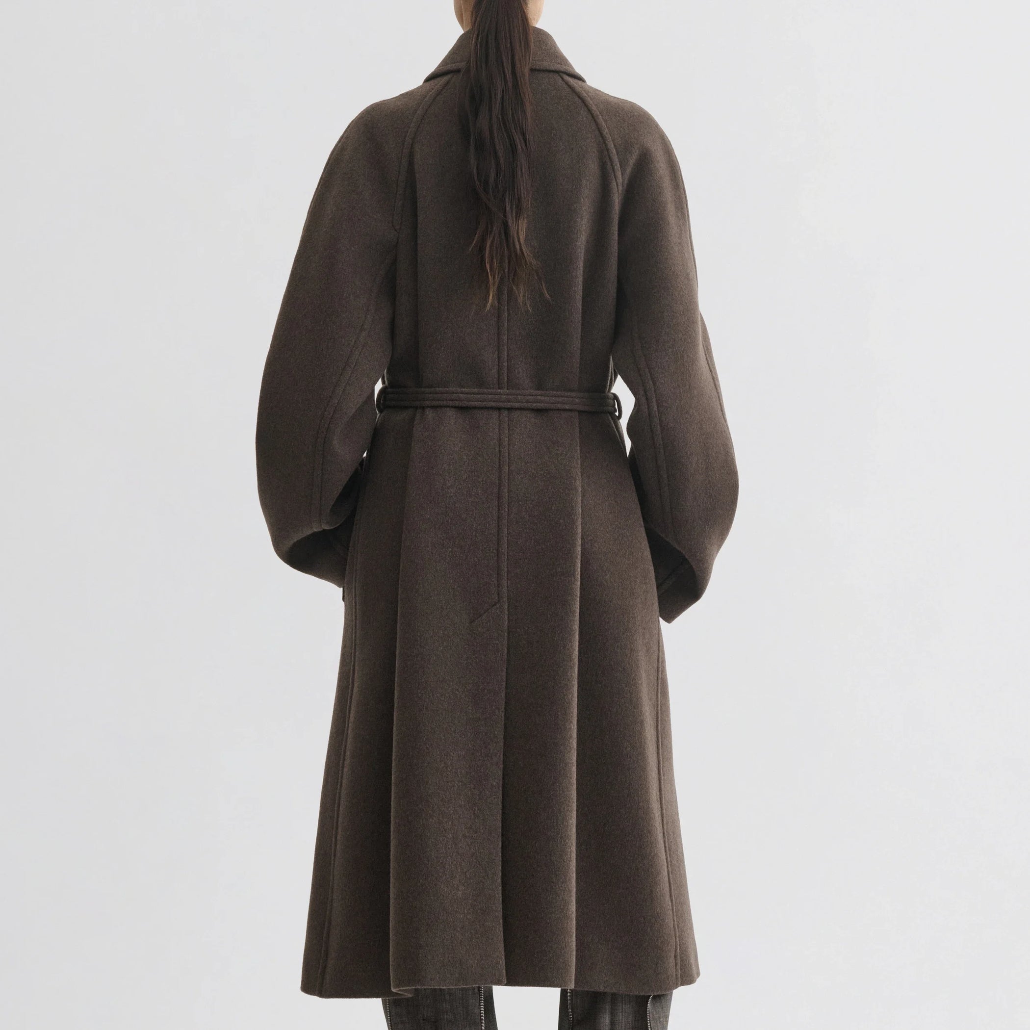 Back view of model wearing curve shoulder coat in brown cashmere.