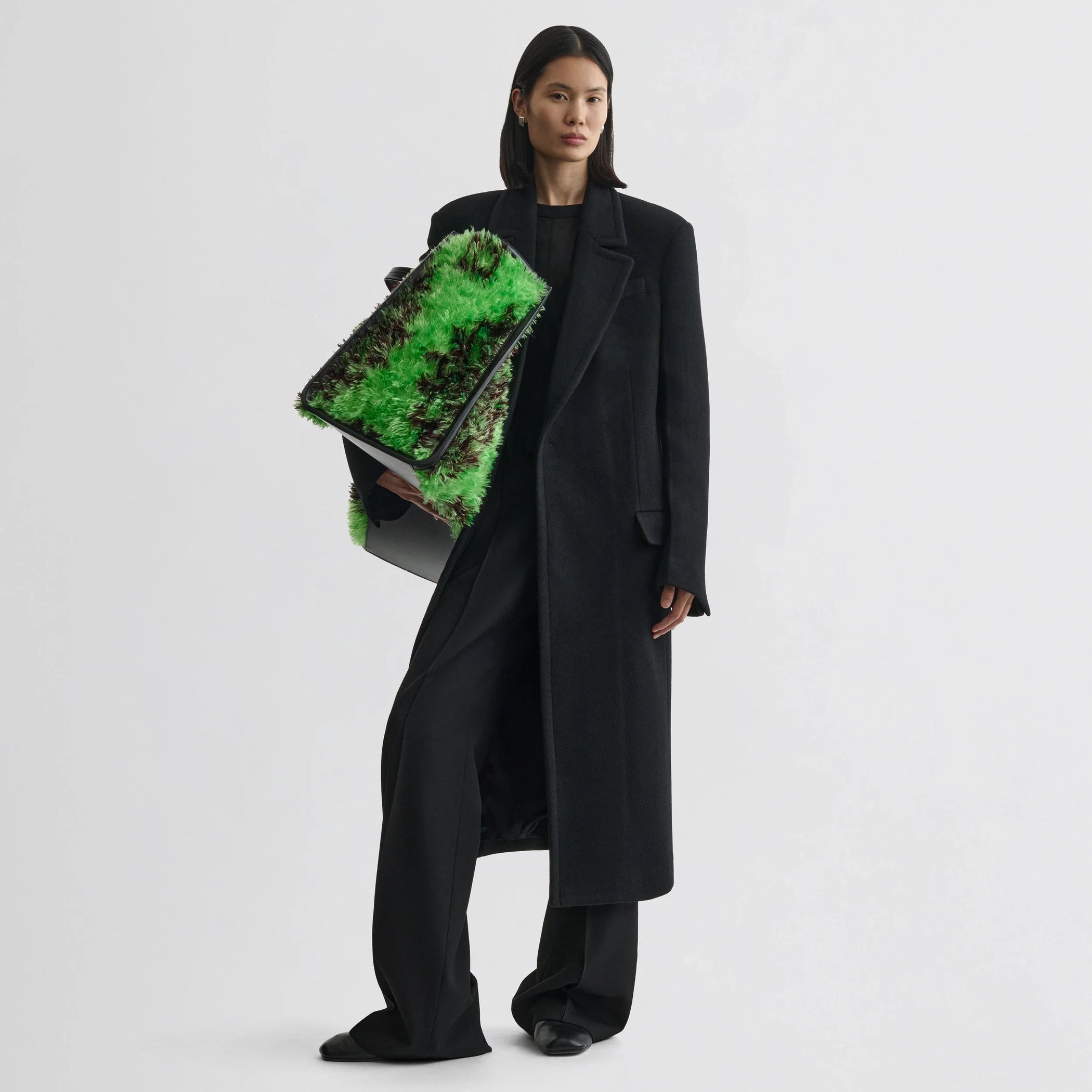 Front view of model wearing classic coat in black cashmere.