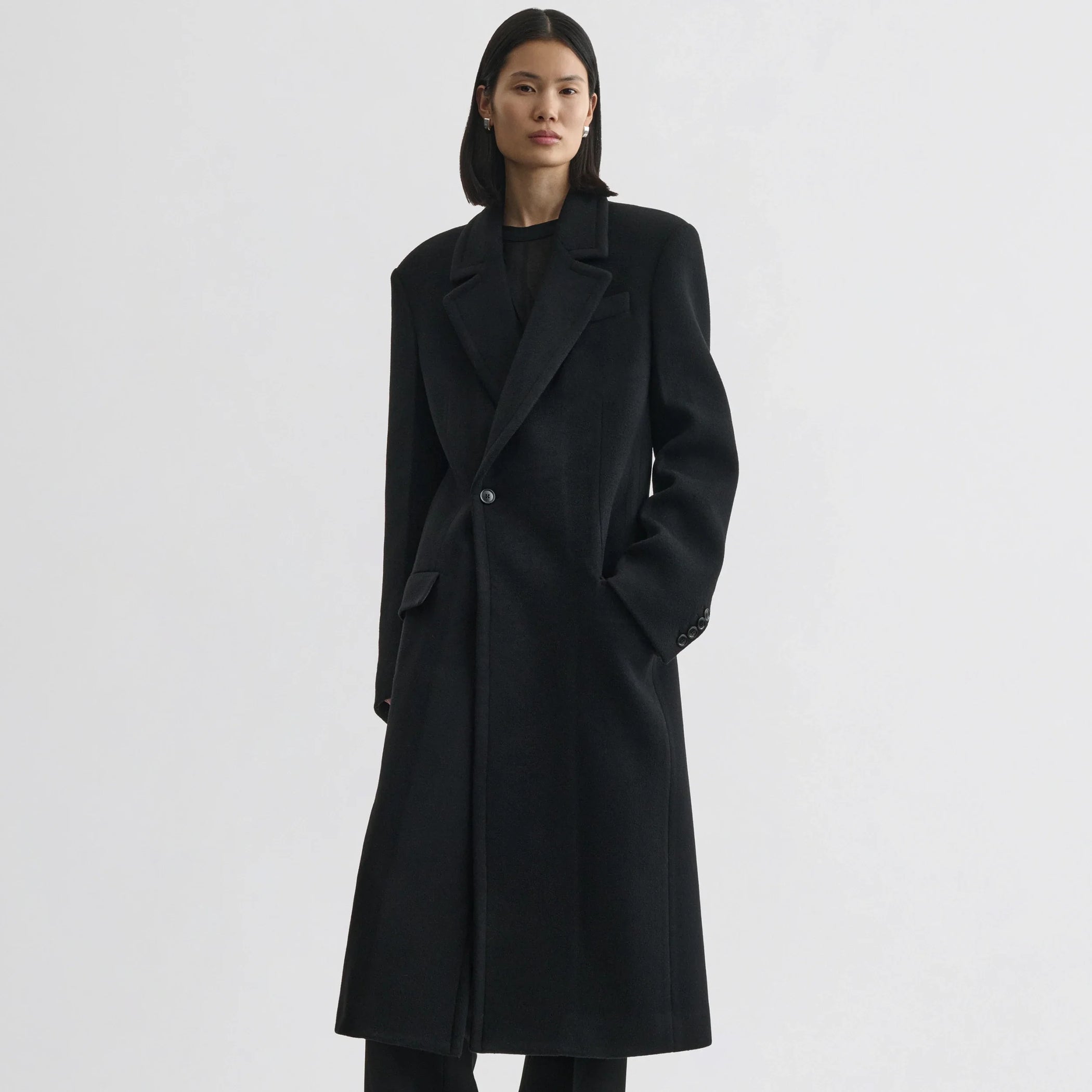 Front view of model wearing classic coat in black cashmere.