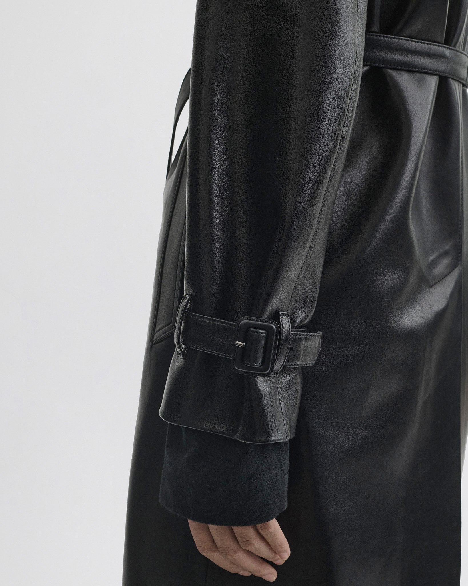 Close up detail view of Short Trench in black leather