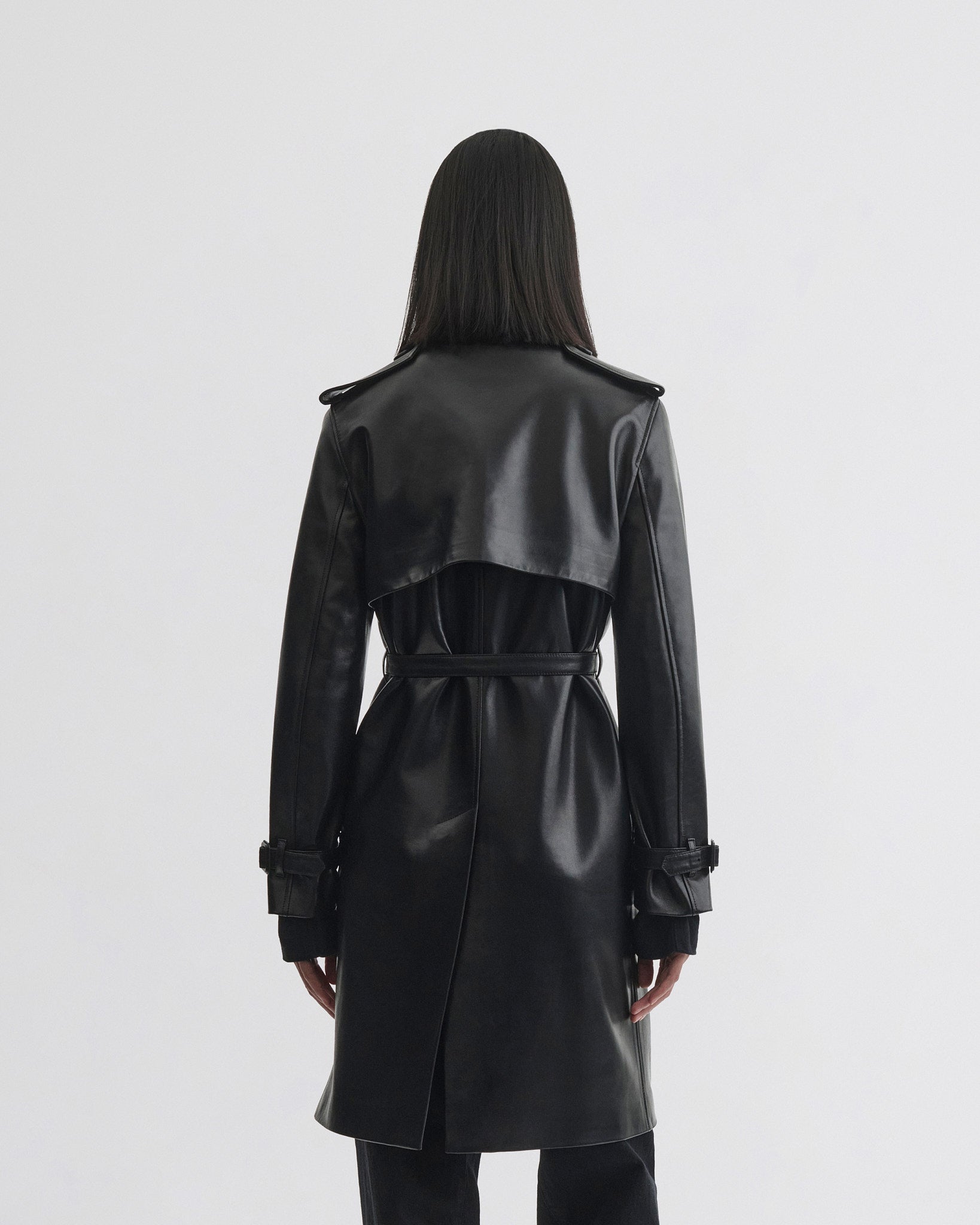 Back view of model wearing Short Trench in black leather